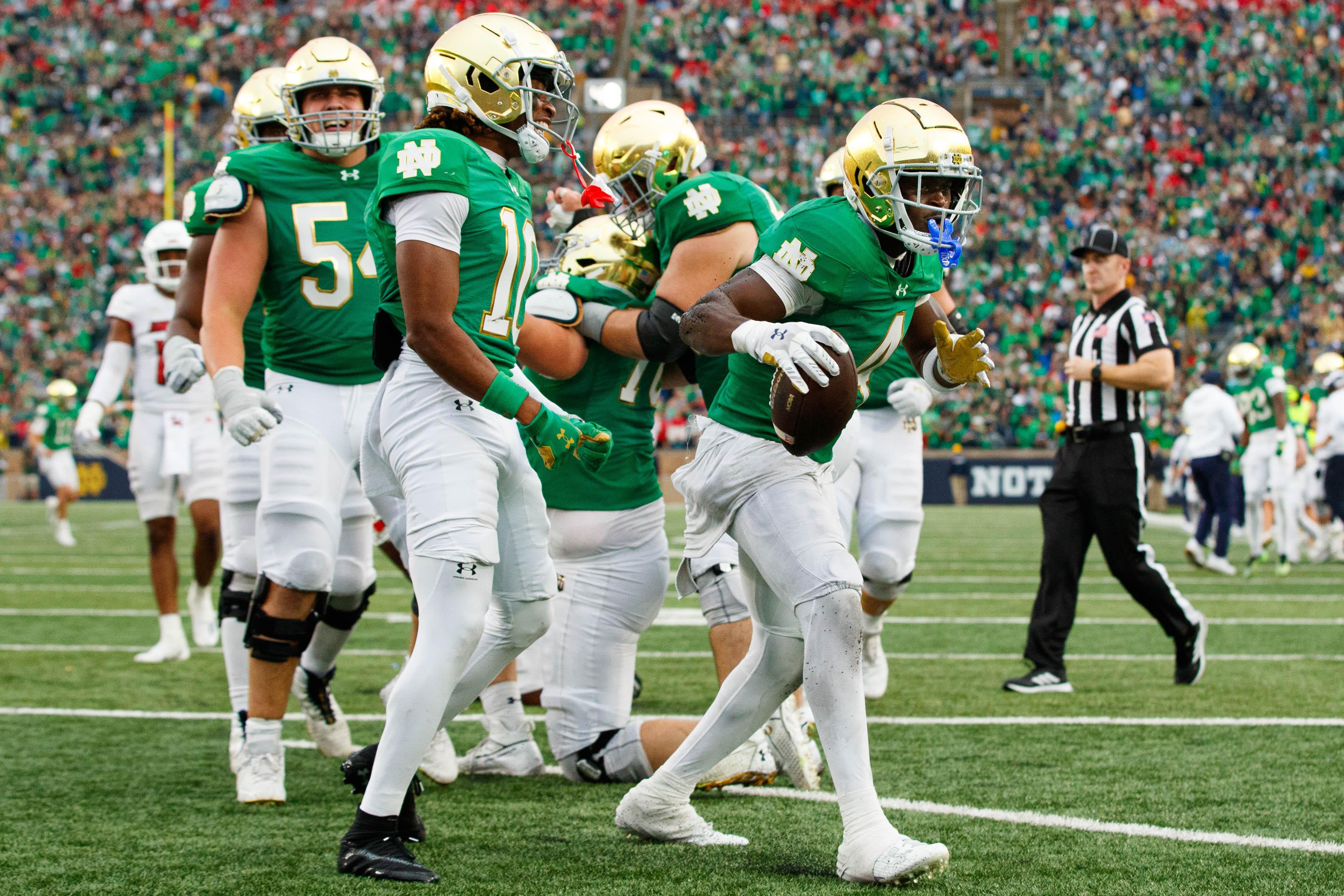 Notre Dame running back Jeremiyah Love (4) celebrates scoring a touchdown during a NCAA college football game between Notre Dame and Louisville at Notre Dame Stadium.