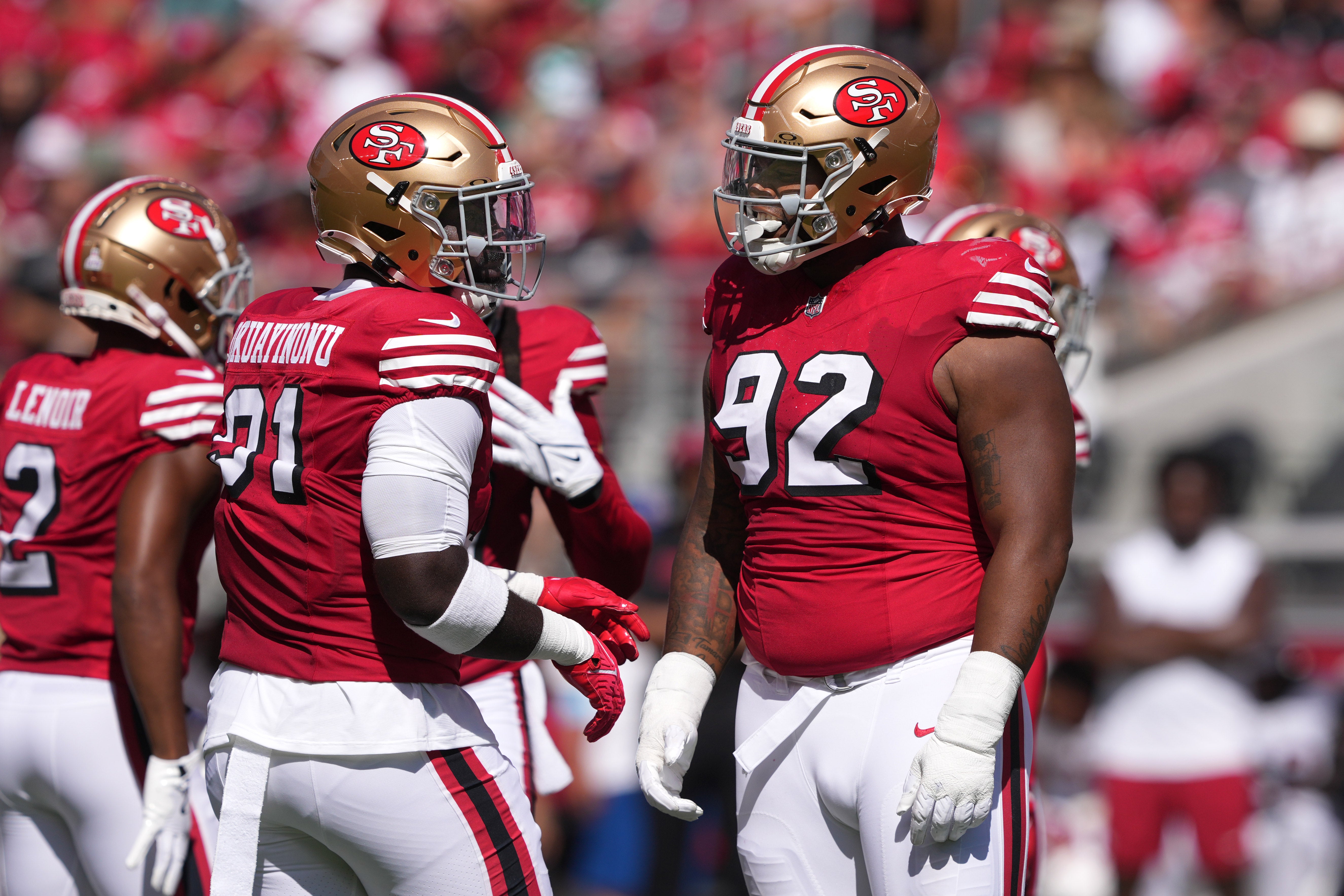 San Francisco 49ers defensive tackles Sam Okuayinonu (left) and Jordan Elliott (92) talk during the first quarter against the Arizona Cardinals at Levi's Stadium.