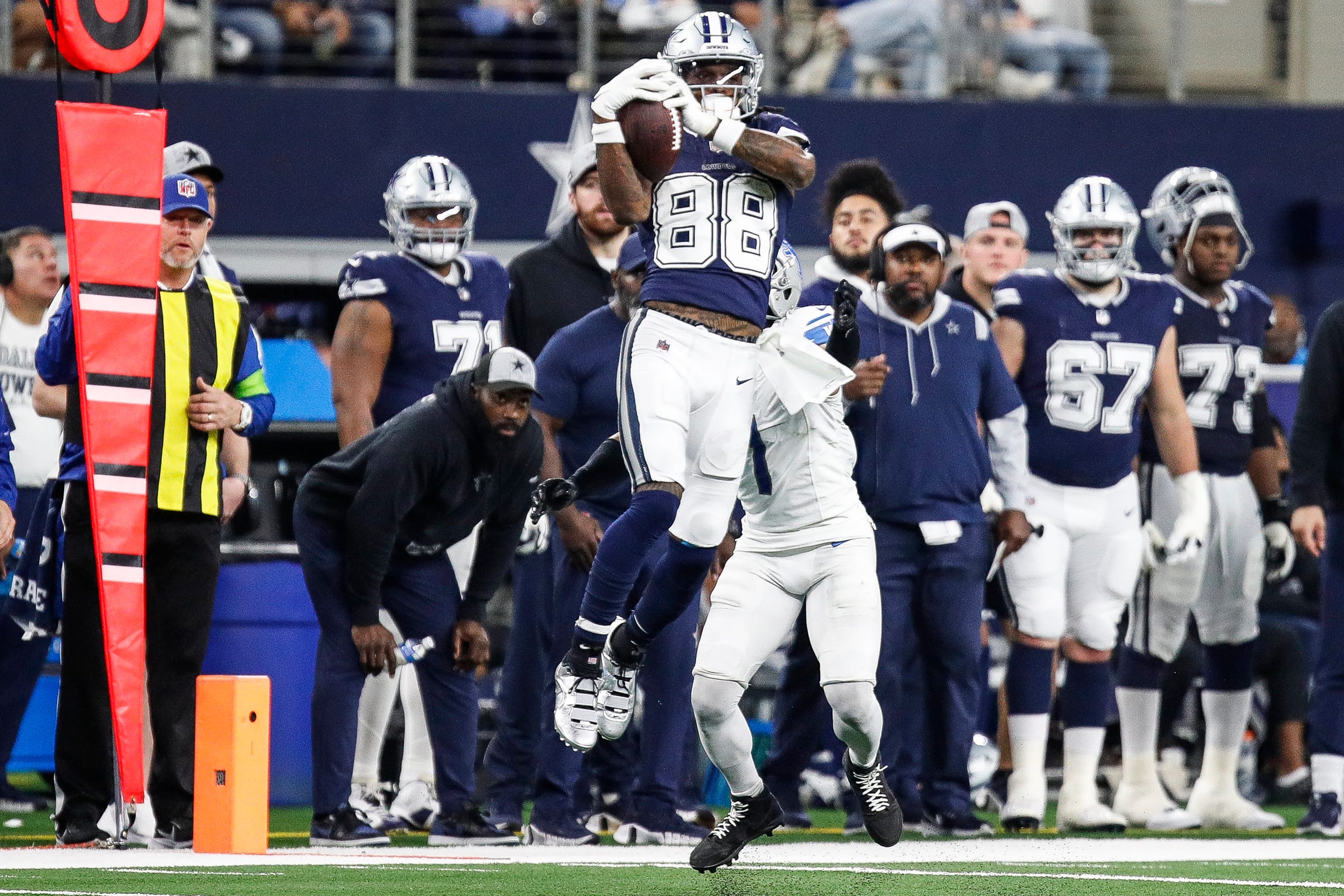Cowboys wide receiver CeeDee Lamb makes a catch against Lions cornerback Cameron Sutton during the second half of the Lions' 20-19 loss at AT&T Stadium in Arlington, Texas on Saturday, Dec. 30, 2023.