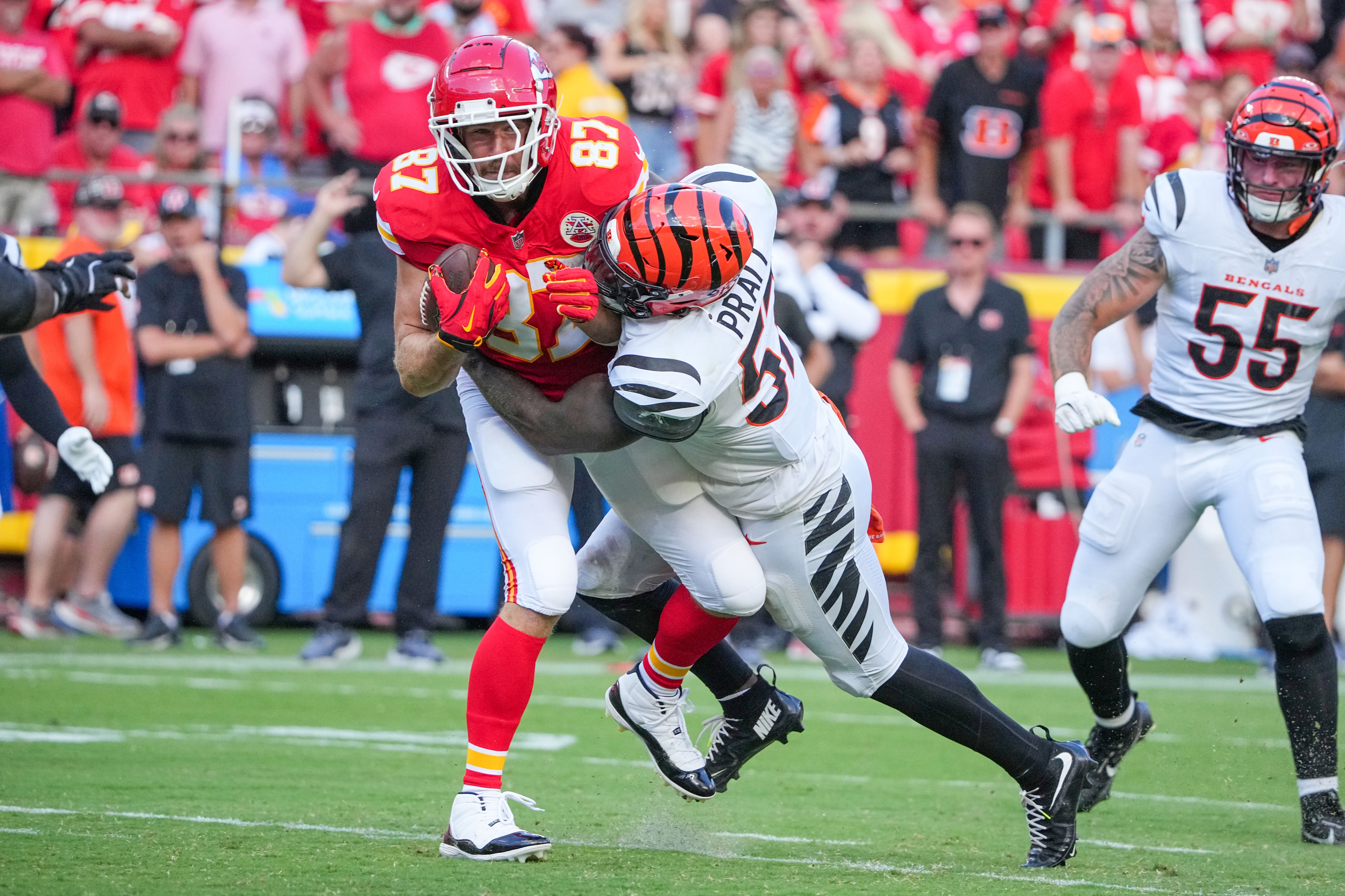 Sep 15, 2024; Kansas City, Missouri, USA; Kansas City Chiefs tight end Travis Kelce (87) catches a pass and is tackled by Cincinnati Bengals linebacker Germaine Pratt (57) during the first half at GEHA Field at Arrowhead Stadium.