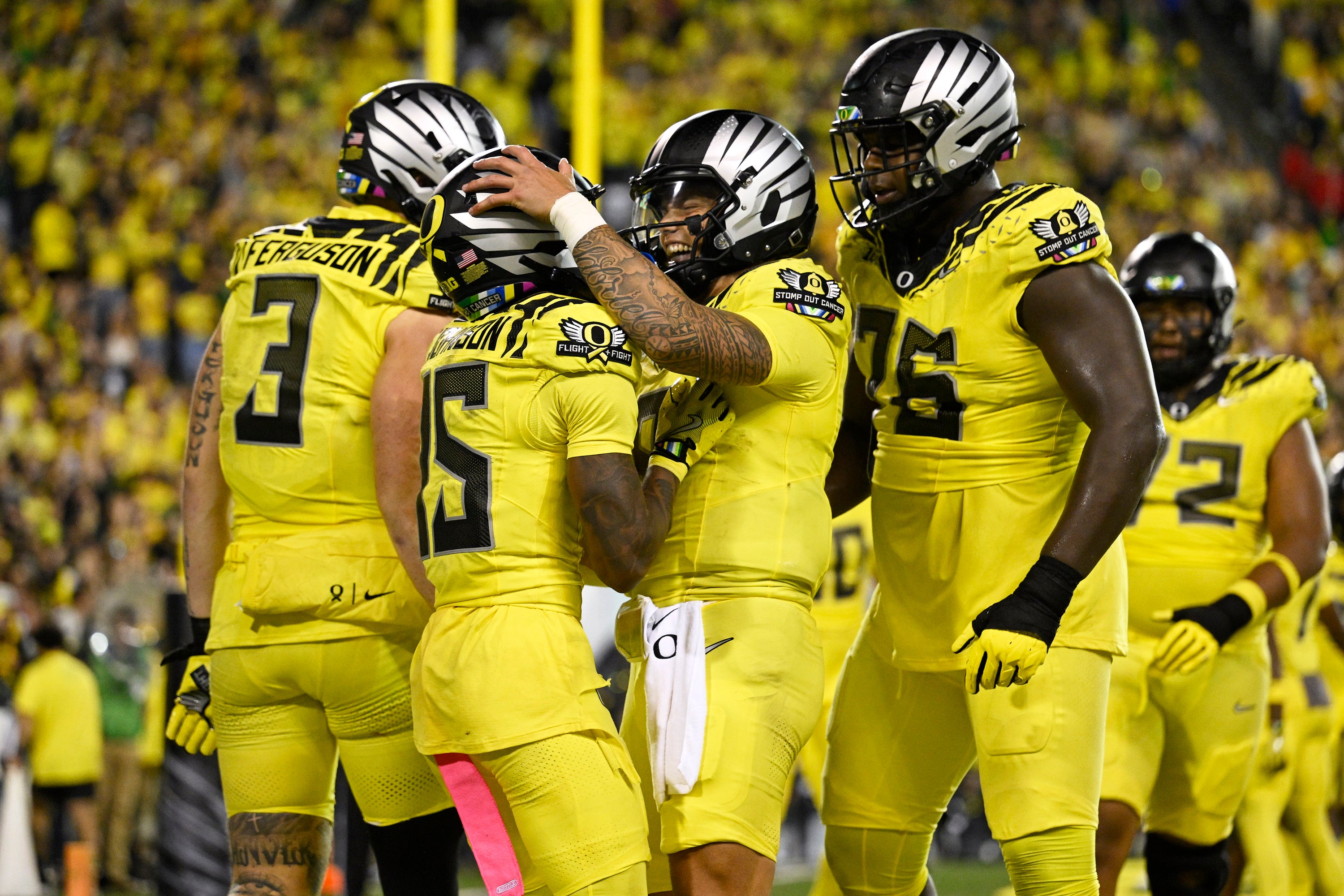 Oregon Ducks wide receiver Tez Johnson (15), left, celebrates catching a touchdown pass with Oregon Ducks quarterback Dillon Gabriel (8) during the second half against the Michigan State Spartans at Autzen Stadium.