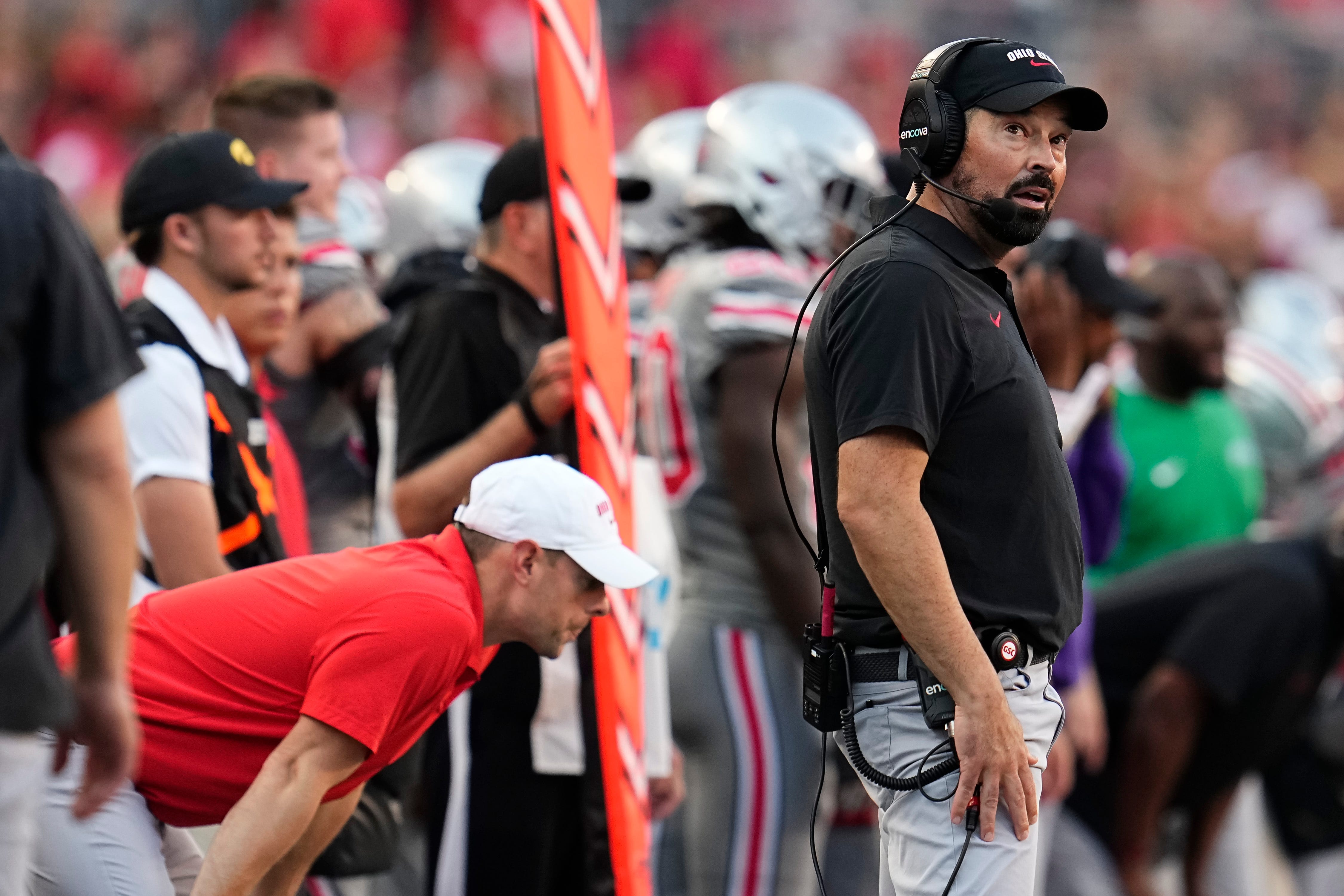 Ohio State Buckeyes head coach Ryan Day watches the scoreboard during the second half of the NCAA football game against the Iowa Hawkeyes at Ohio Stadium.