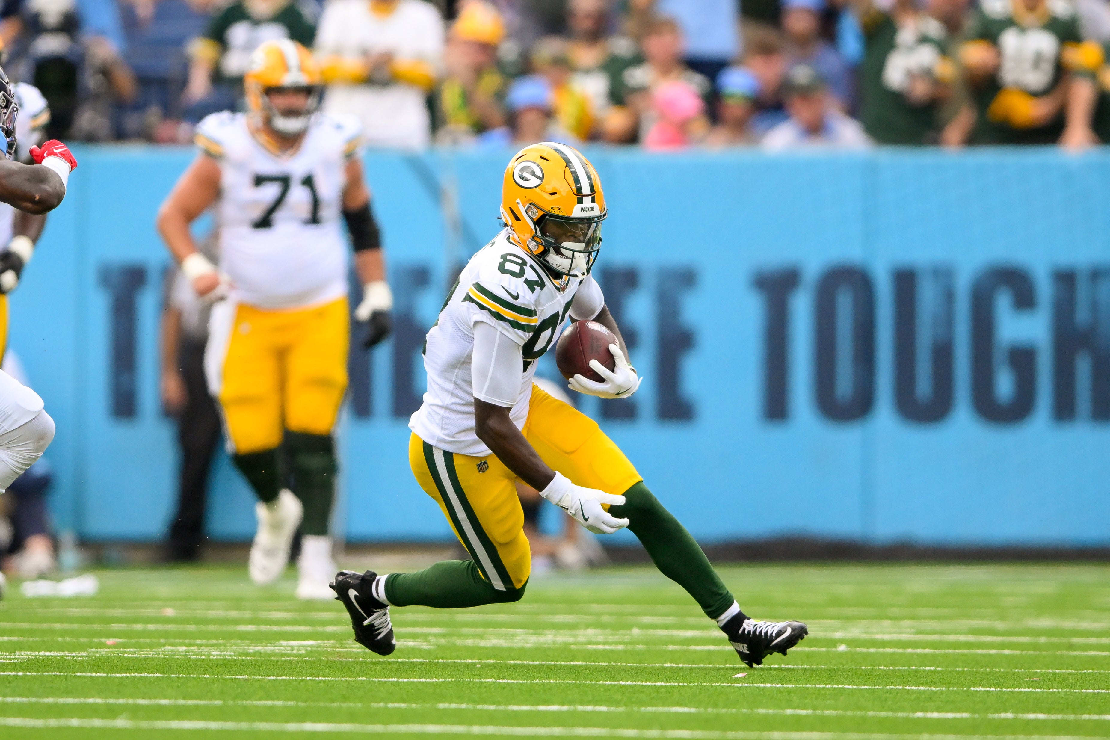 Green Bay Packers wide receiver Romeo Doubs (87) makes a catch and runs the ball against the Tennessee Titans during the first half at Nissan Stadium.