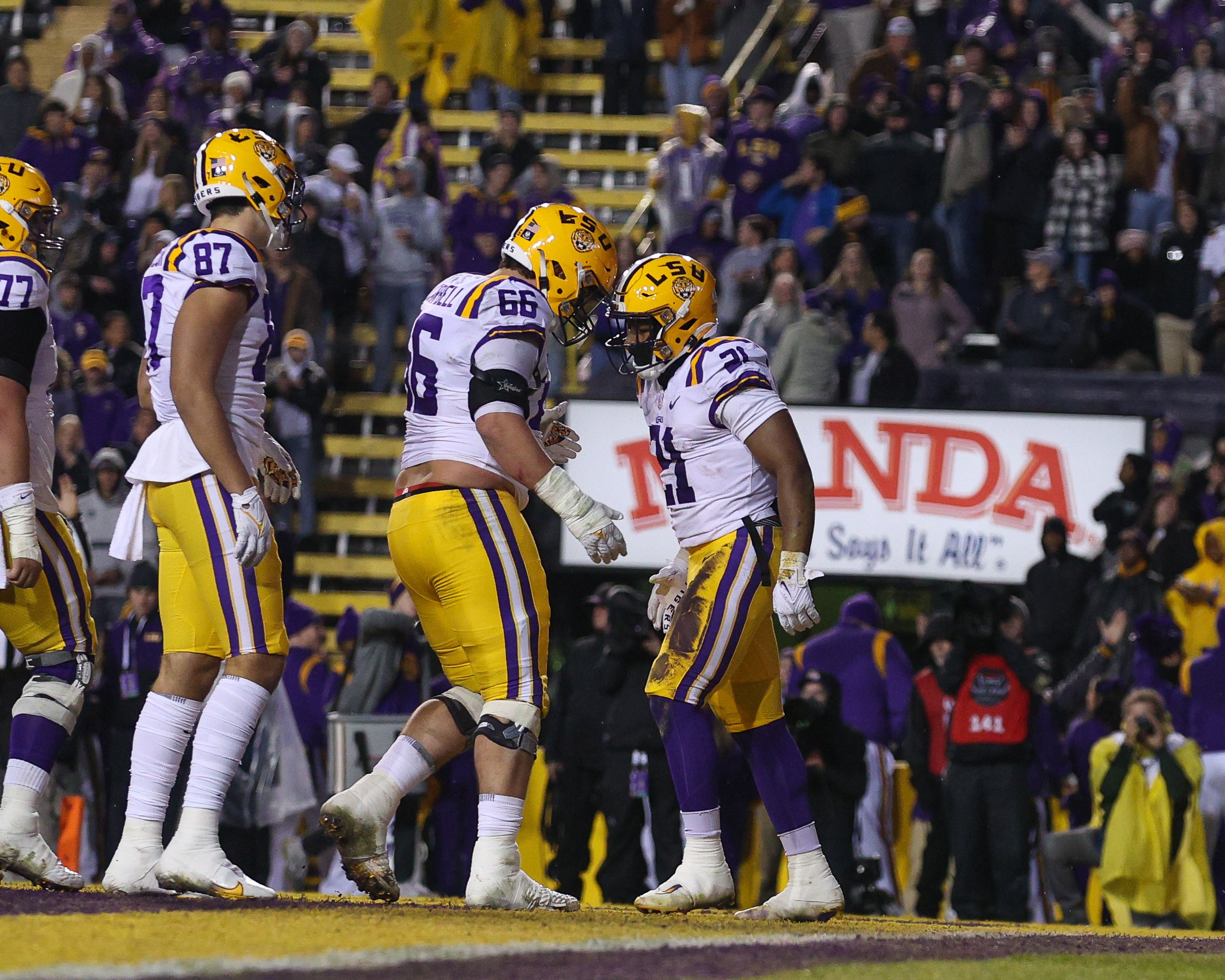 Nov 19, 2022; Baton Rouge, Louisiana, USA; LSU Tigers running back Noah Cain (21) and offensive lineman Will Campbell (66) celebrate scoring a touchdown against the UAB Blazers the first half at Tiger Stadium.