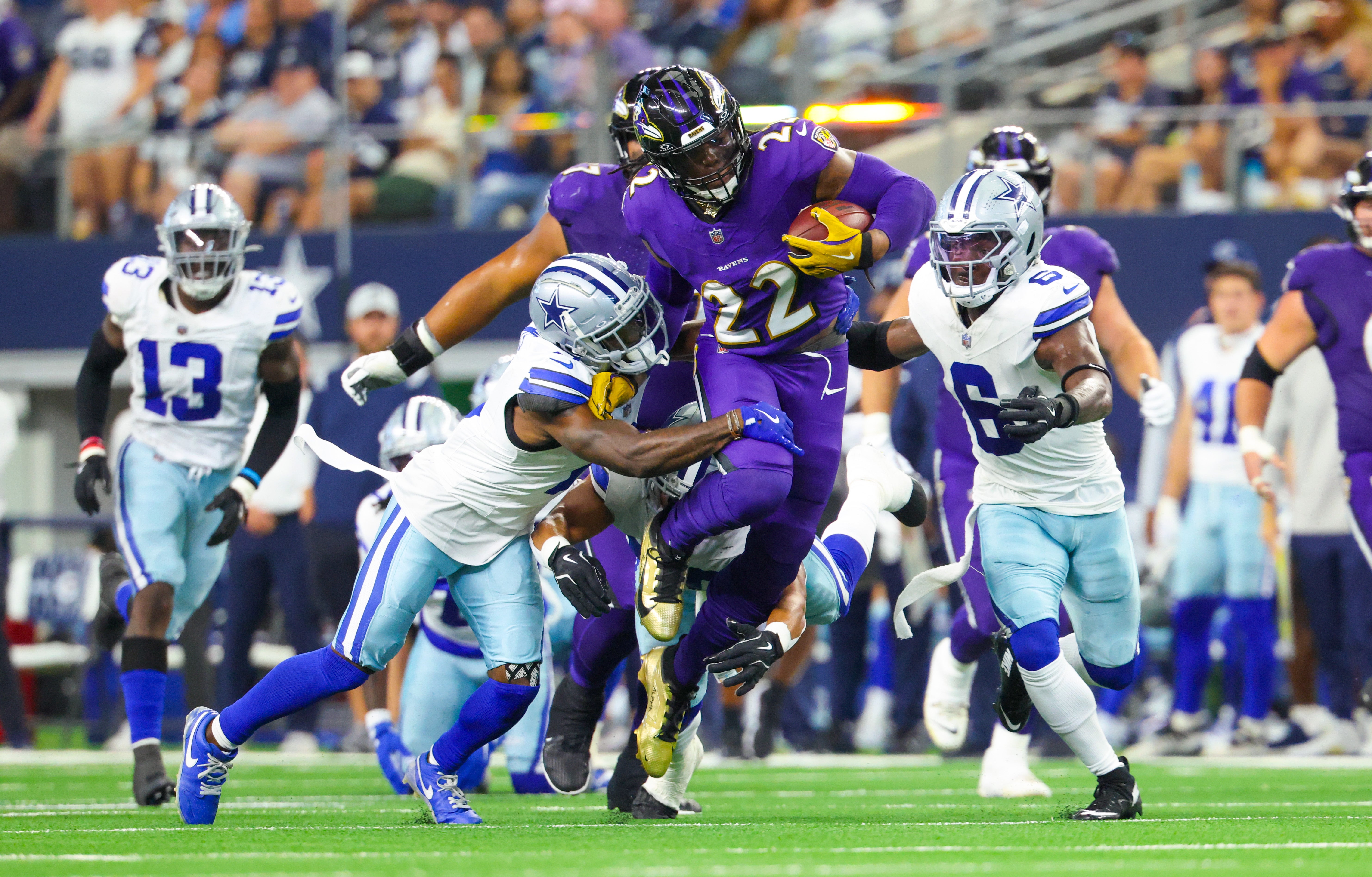 Baltimore Ravens running back Derrick Henry (22) runs during the first half as Dallas Cowboys safety Donovan Wilson (6) and Dallas Cowboys cornerback Jourdan Lewis (2) defend at AT&T Stadium.