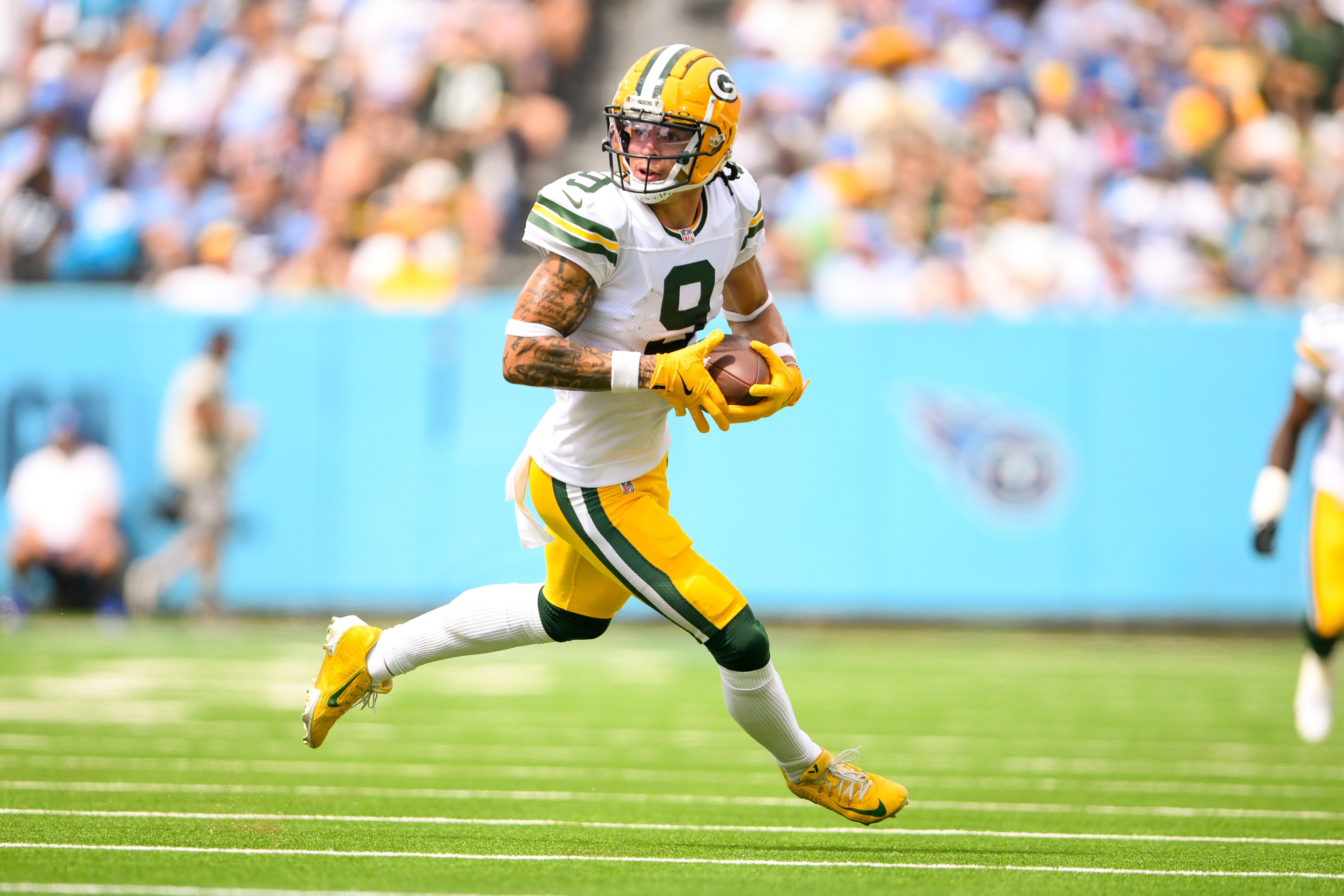 Green Bay Packers wide receiver Christian Watson (9) runs the ball after a made catch against the Tennessee Titans during the first half at Nissan Stadium.