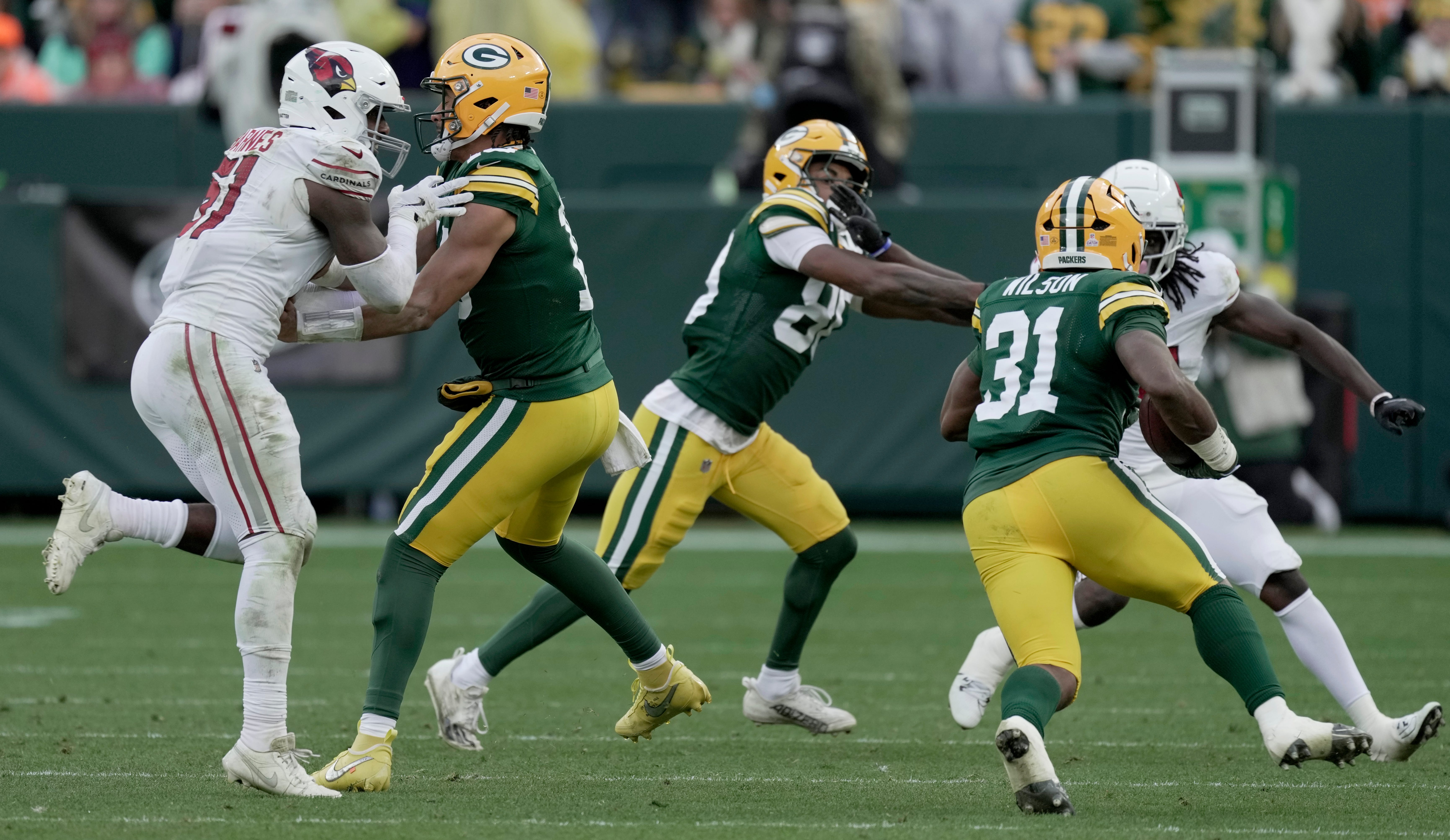 Green Bay Packers quarterback Jordan Love (10) blocks Arizona Cardinals linebacker Krys Barnes (51) during the fourth quarter of their game Sunday, October 13, 2024 at Lambeau Field in Green Bay, Wisconsin. The Green Bay Packers beat the Arizona Cardinals 34-13.