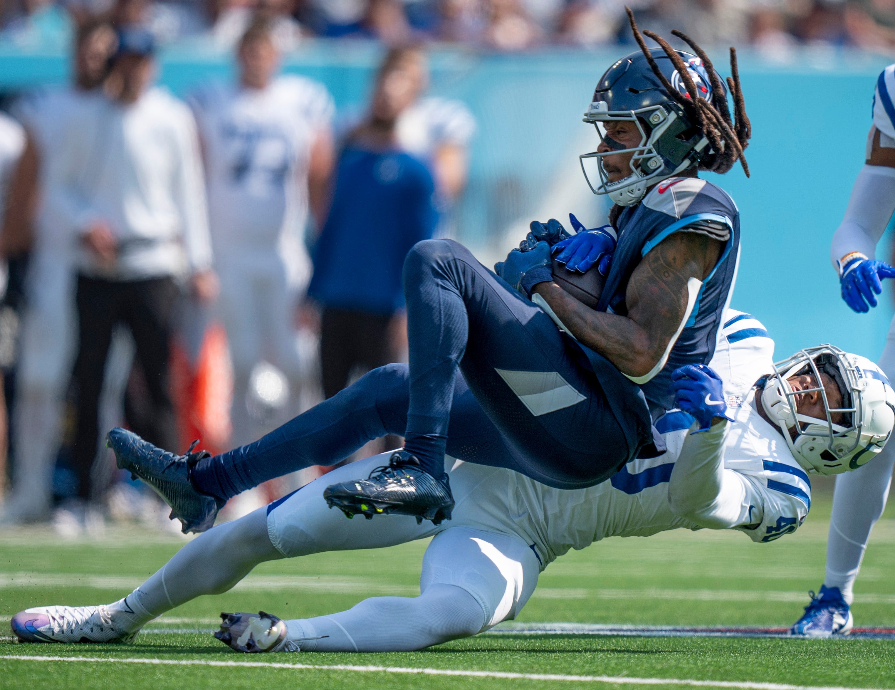 Tennessee Titans wide receiver DeAndre Hopkins (10) is tackled after a catch by Indianapolis Colts cornerback Jaylon Jones (40) during the first half of their game at Nissan Stadium in Nashville, Tenn., Monday, Oct. 14, 2024.