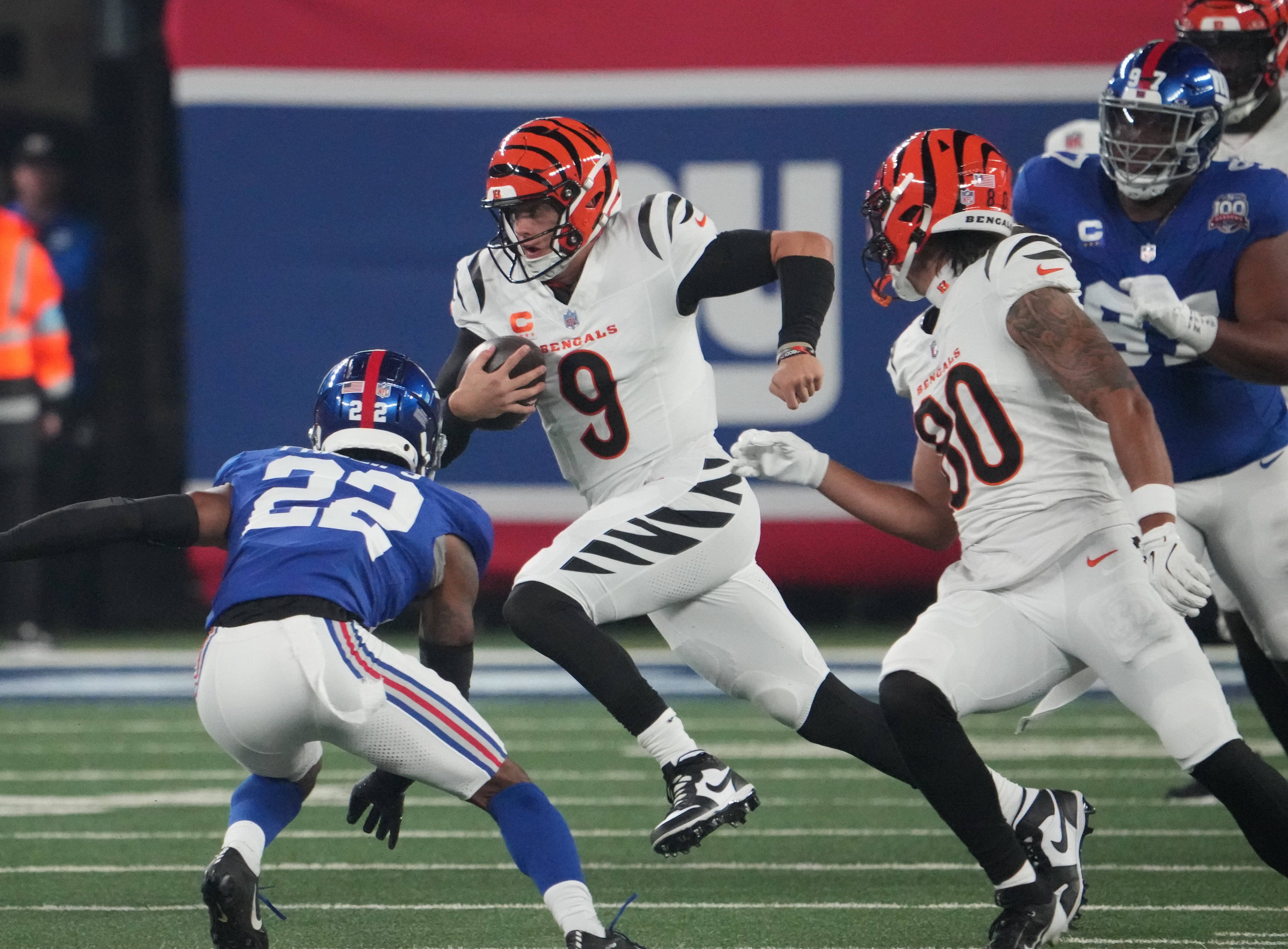 Oct 13, 2024; East Rutherford, New Jersey, USA; Cincinnati Bengals quarterback Joe Burrow (9) runs the ball against the New York Giants during the first quarter at MetLife Stadium.