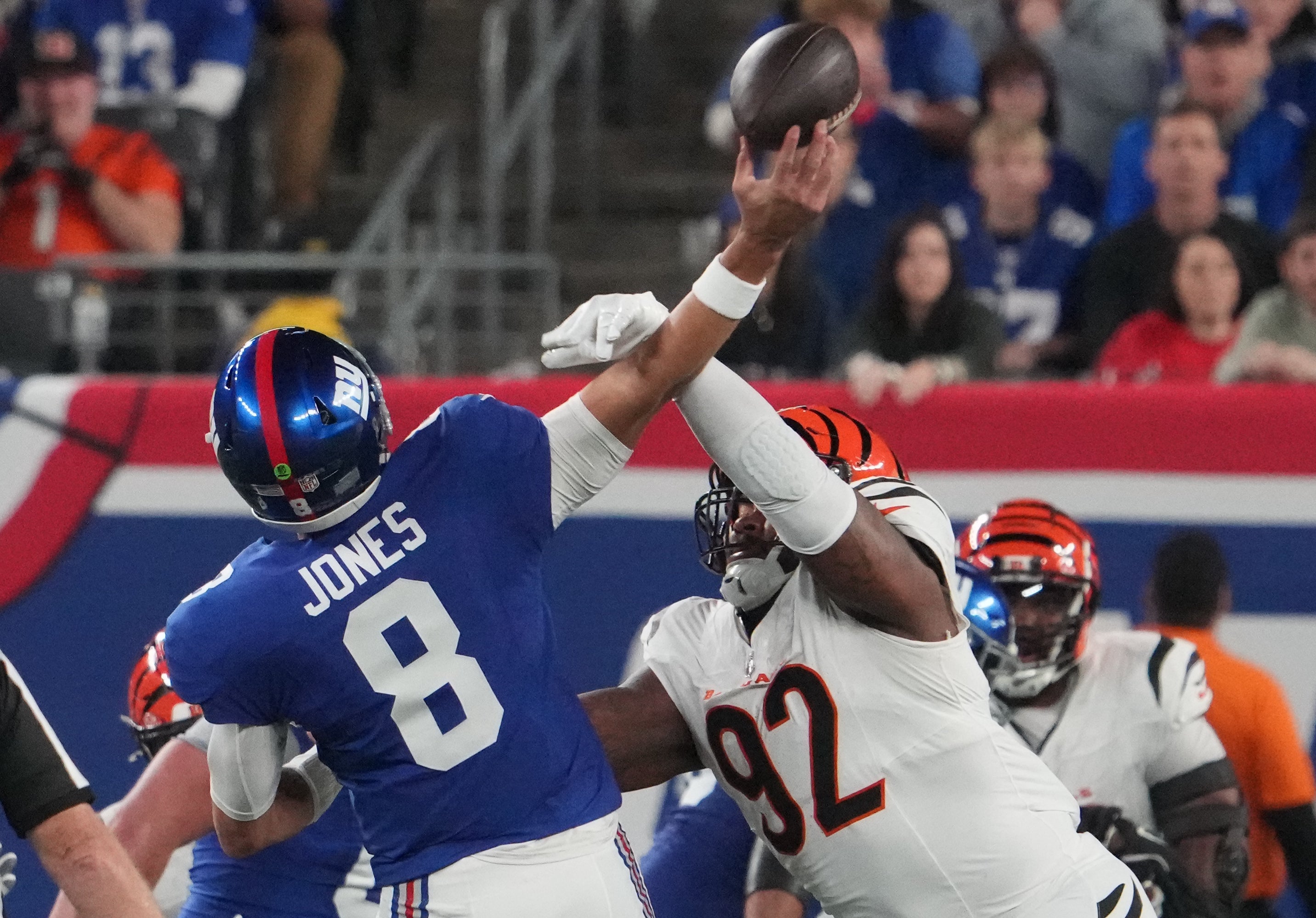 Oct 13, 2024; East Rutherford, New Jersey, USA; Cincinnati Bengals defensive tackle B.J. Hill (92) forces an interception on a throw by New York Giants quarterback Daniel Jones (8) during the first quarter at MetLife Stadium.