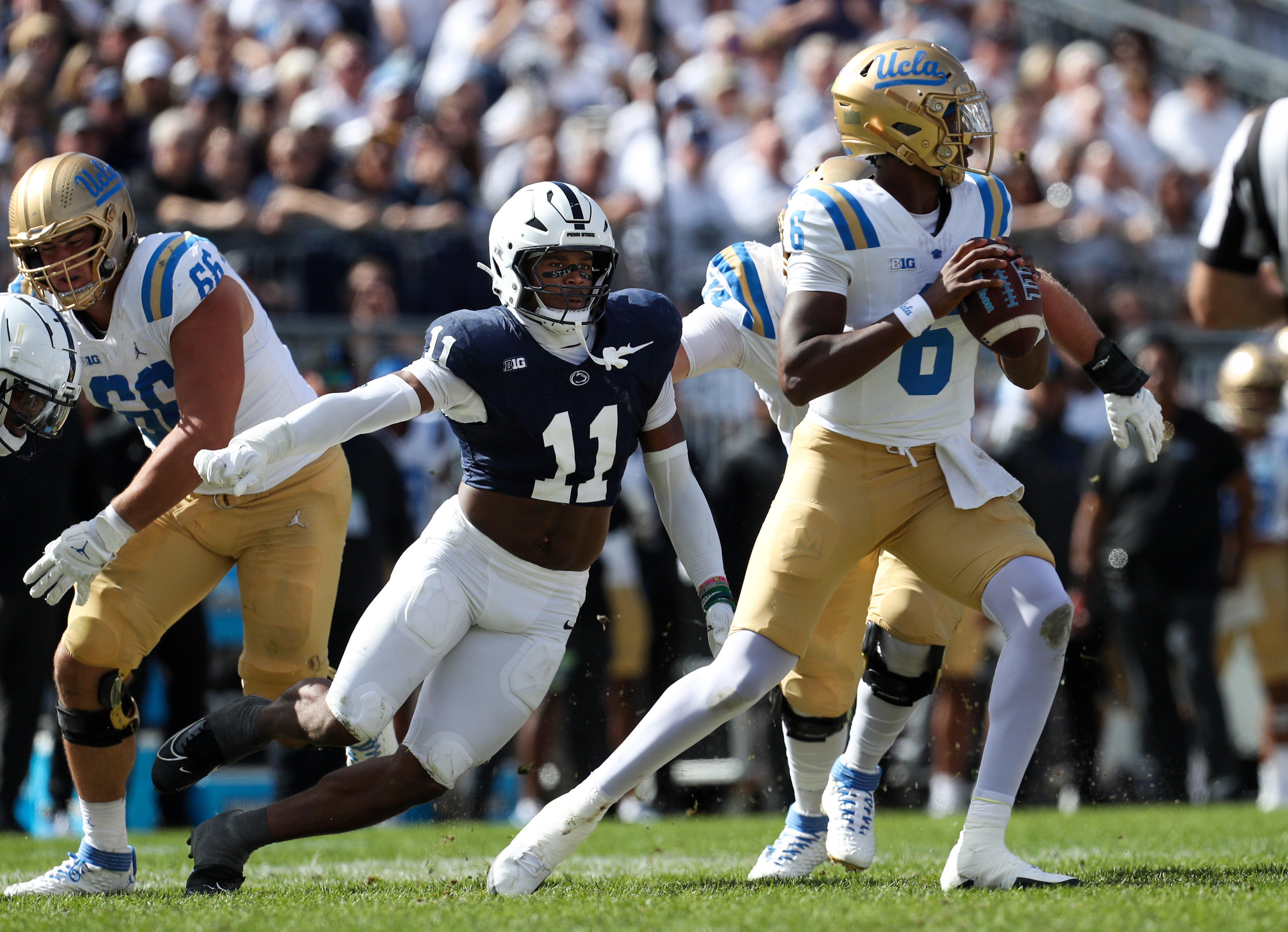 Penn State Nittany Lions defensive end Abdul Carter (11) pressures UCLA Bruins quarterback Jaylin Davies (6) during the third quarter at Beaver Stadium.
