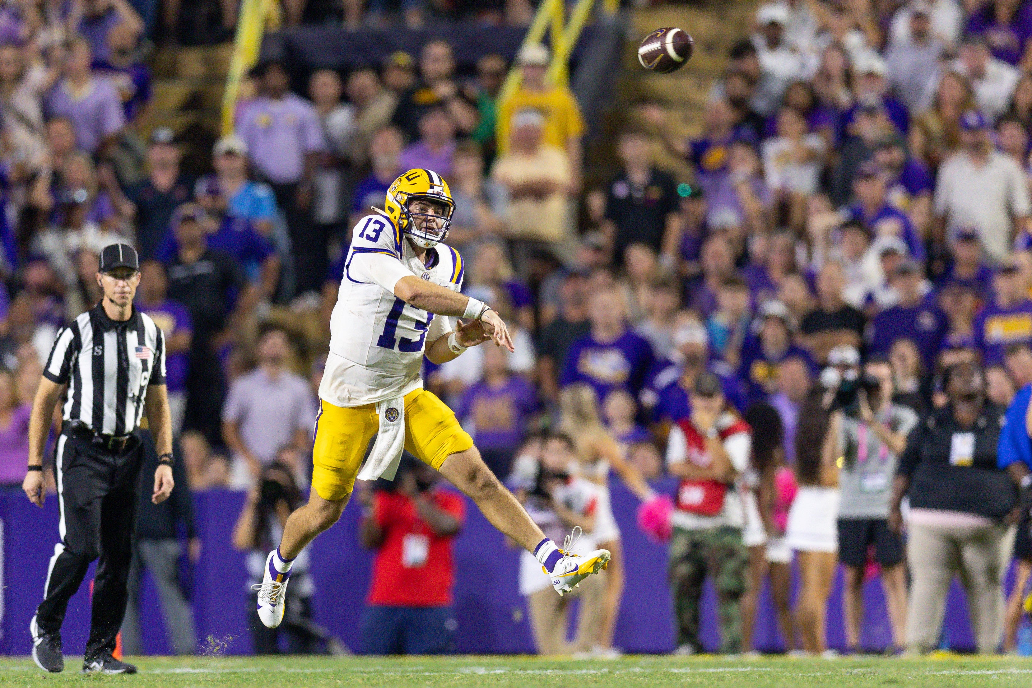 Oct 12, 2024; Baton Rouge, Louisiana, USA; LSU Tigers quarterback Garrett Nussmeier (13) throws for a first down against the Mississippi Rebels during the second half at Tiger Stadium.