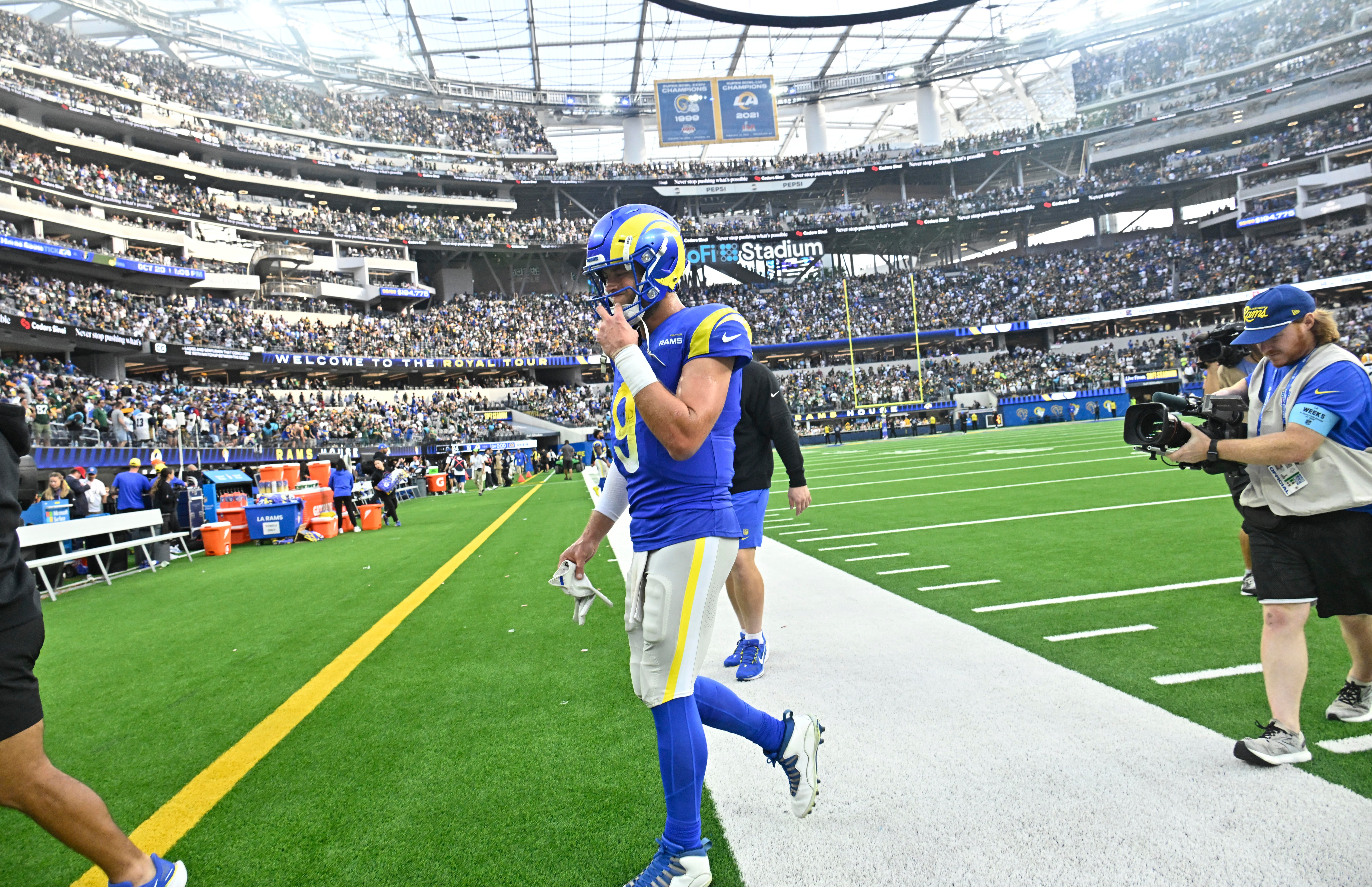 Los Angeles Rams quarterback Matthew Stafford (9) walks off the field after losing to the Green Bay Packers at SoFi Stadium.