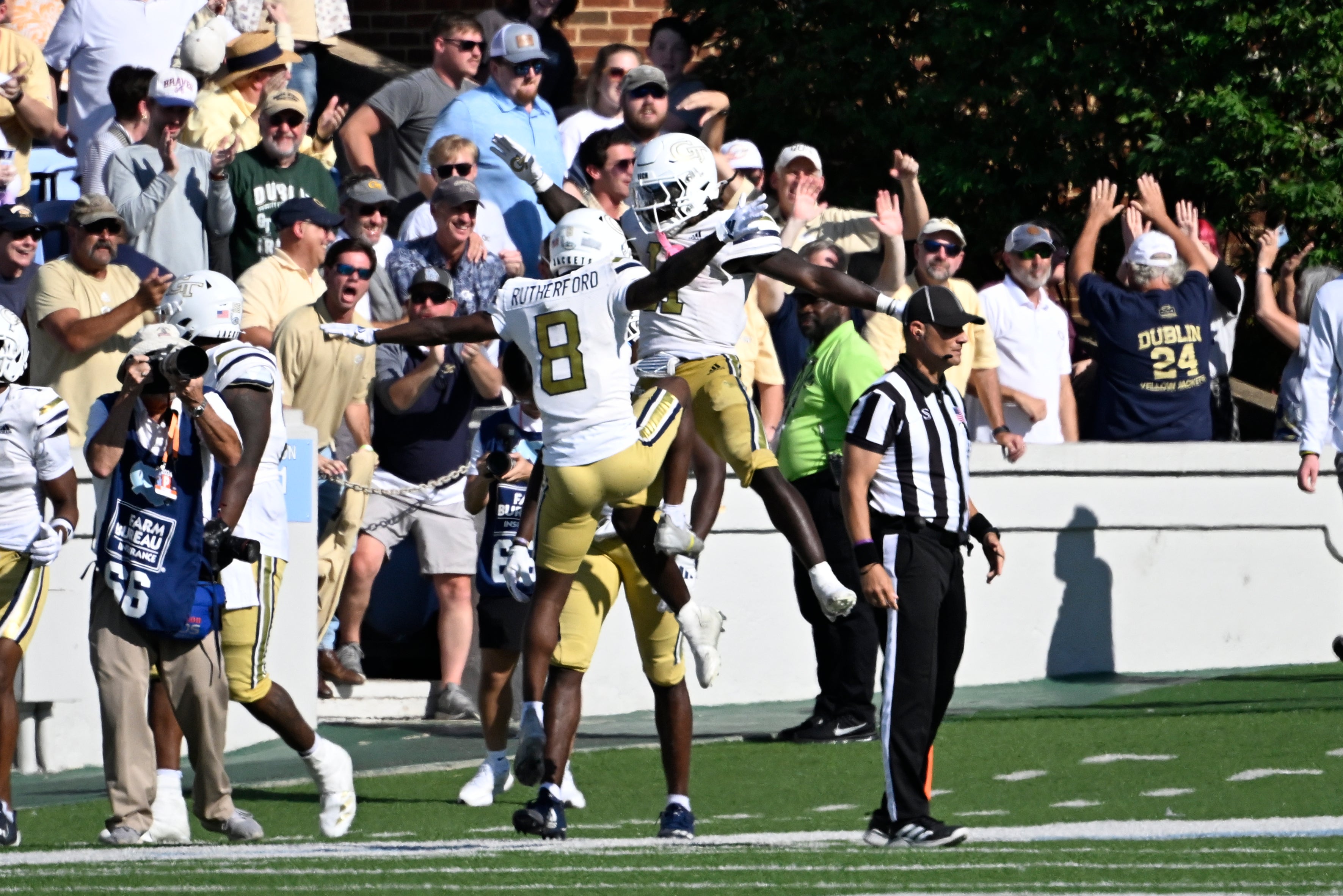 Georgia Tech Yellow Jackets running back Jamal Haynes (11) celebrates with wide receiver Malik Rutherford (8) after scoring a touchdown in the last minute of the fourth quarter at Kenan Memorial Stadium.