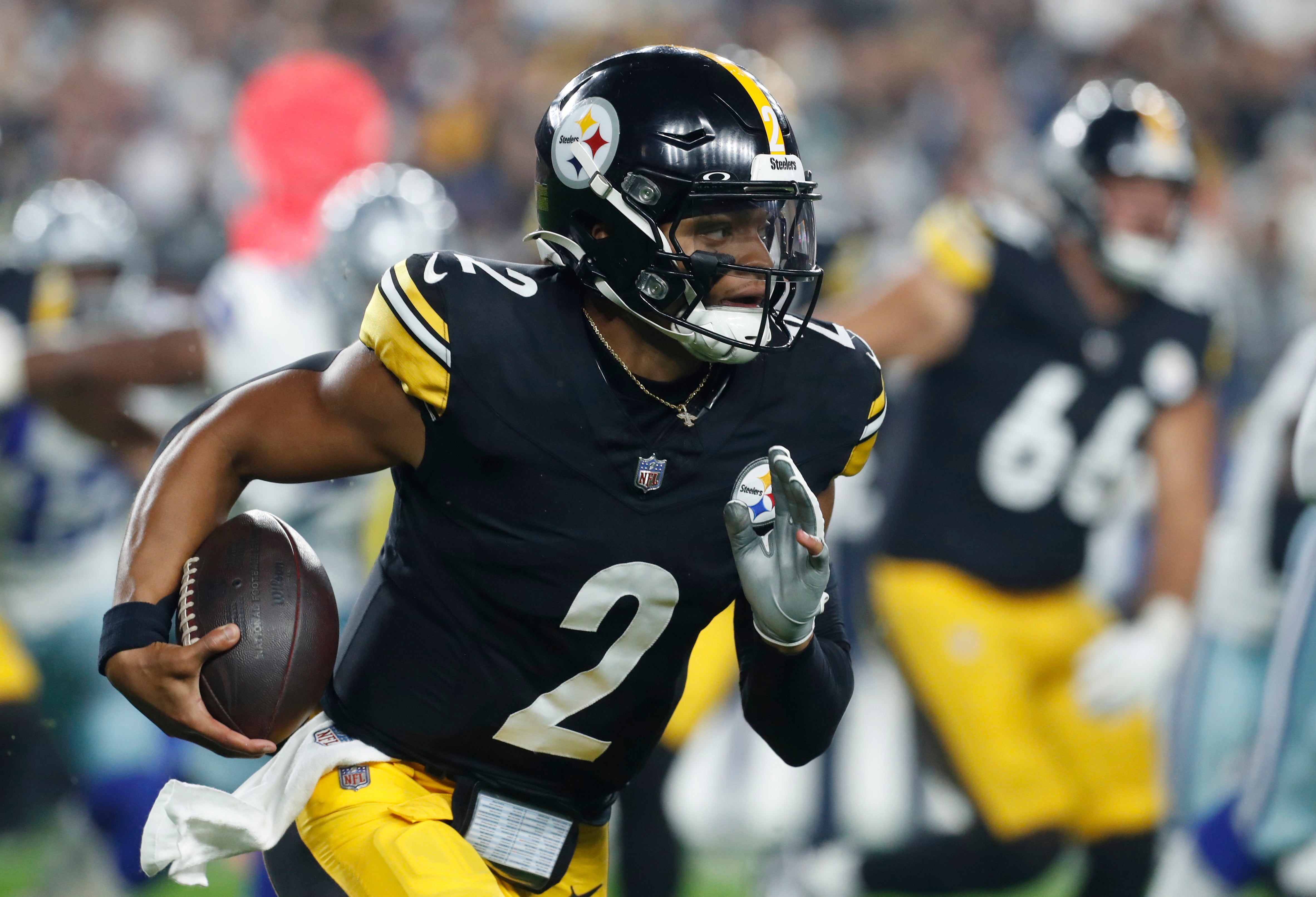 Oct 6, 2024; Pittsburgh, Pennsylvania, USA; Pittsburgh Steelers quarterback Justin Fields (2) runs the ball against the Dallas Cowboys during the first quarter at Acrisure Stadium.
