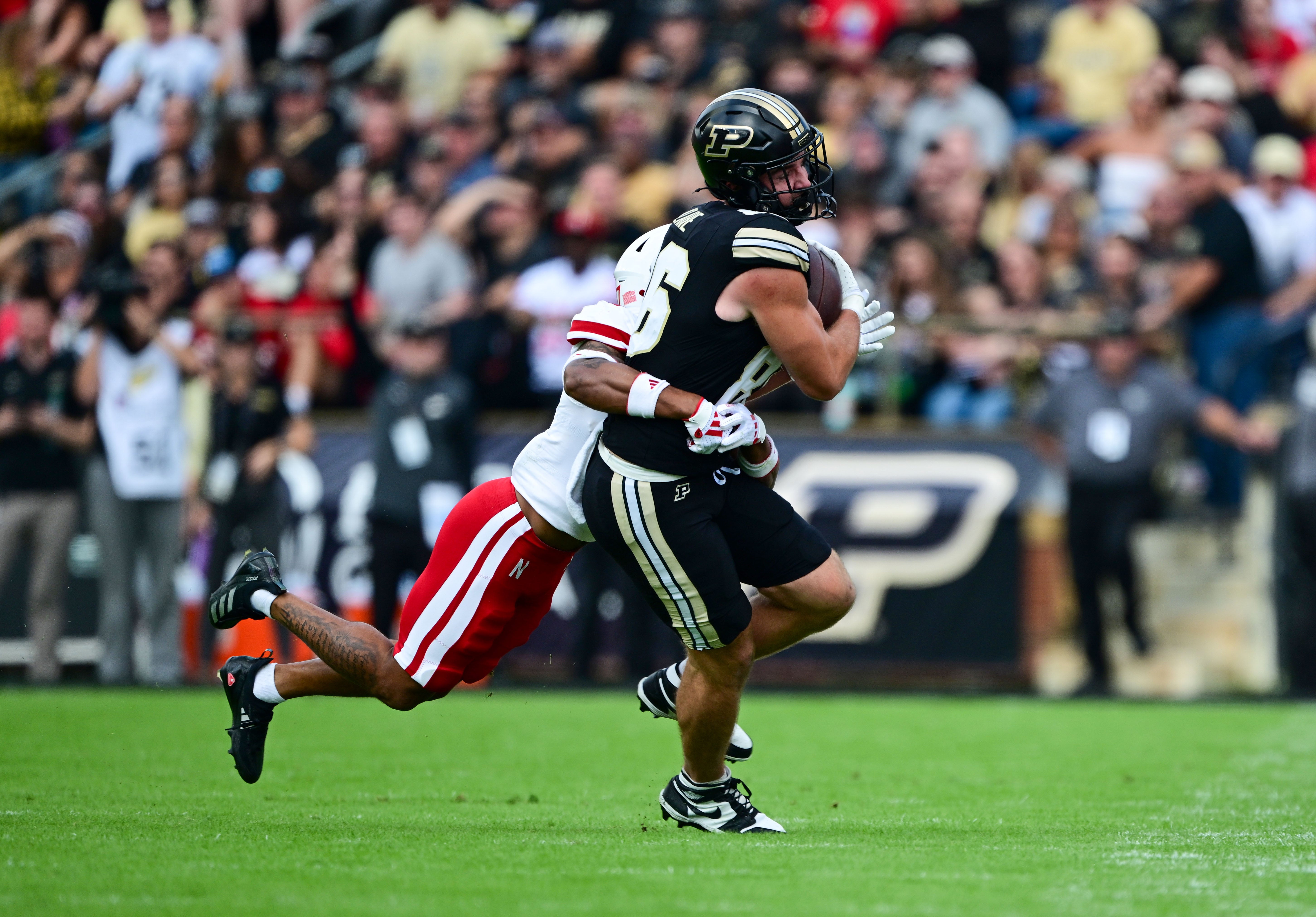 Purdue Boilermakers tight end Max Klare (86) is tackled by Nebraska Cornhuskers defensive back Malcolm Hartzog Jr. (7) during the second half at Ross-Ade Stadium.