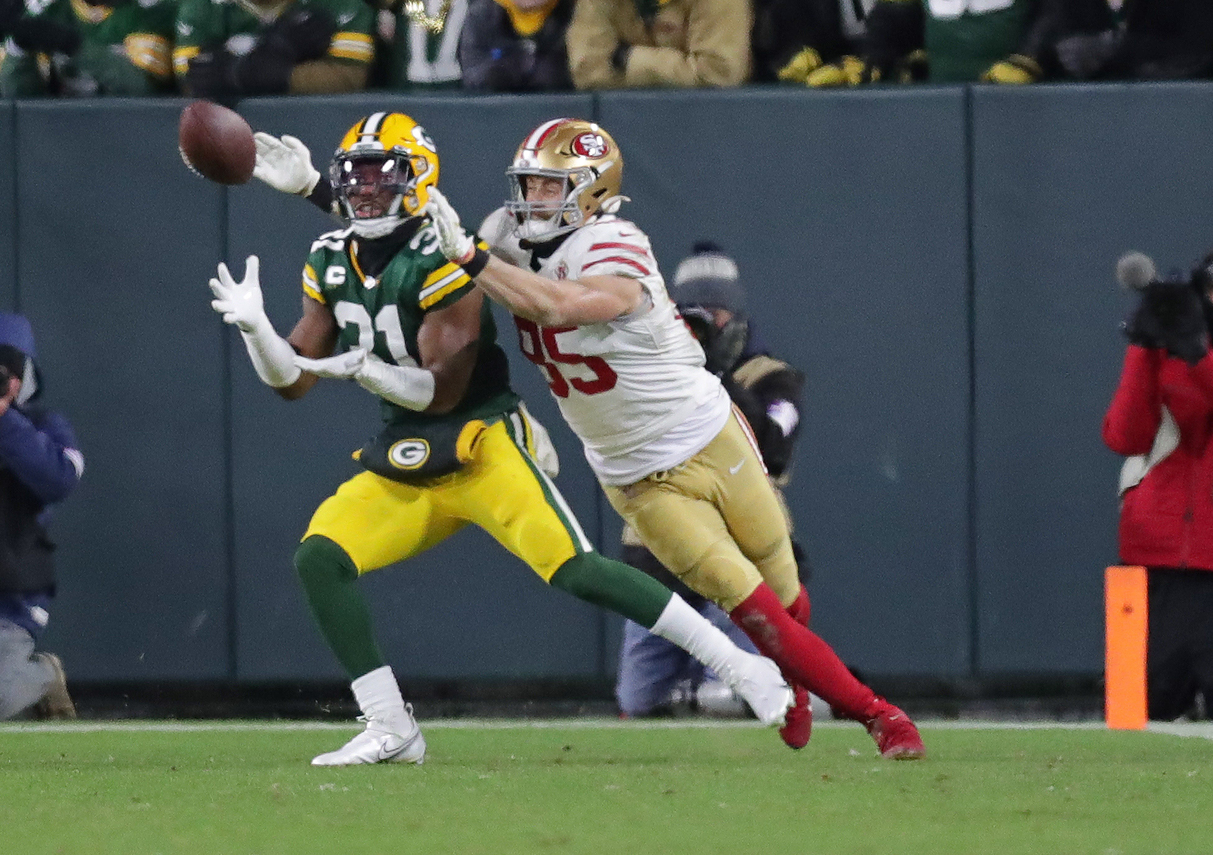 Green Bay Packers safety Adrian Amos (31) intercepts a pass intended for San Francisco 49ers tight end George Kittle (85) during the first half of the divisional playoff game at Lambeau Field in Green Bay on Saturday, Jan. 22, 2022.