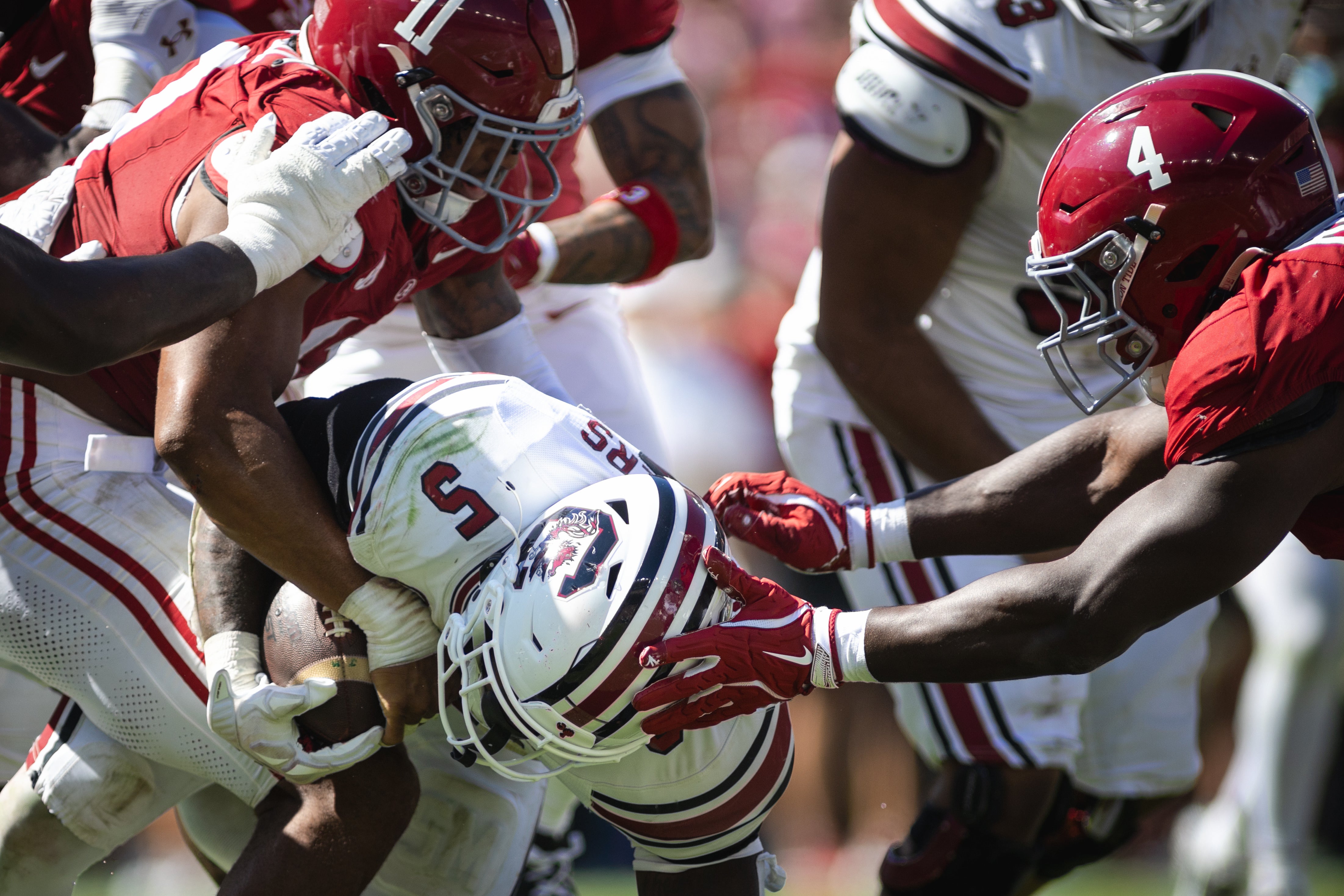 Oct 12, 2024; Tuscaloosa, Alabama, USA; Alabama Crimson Tide linebacker Jihaad Campbell (11) and Alabama Crimson Tide linebacker Qua Russaw (4) bring down South Carolina Gamecocks running back Raheim Sanders (5) during the third quarter at Bryant-Denny Stadium.