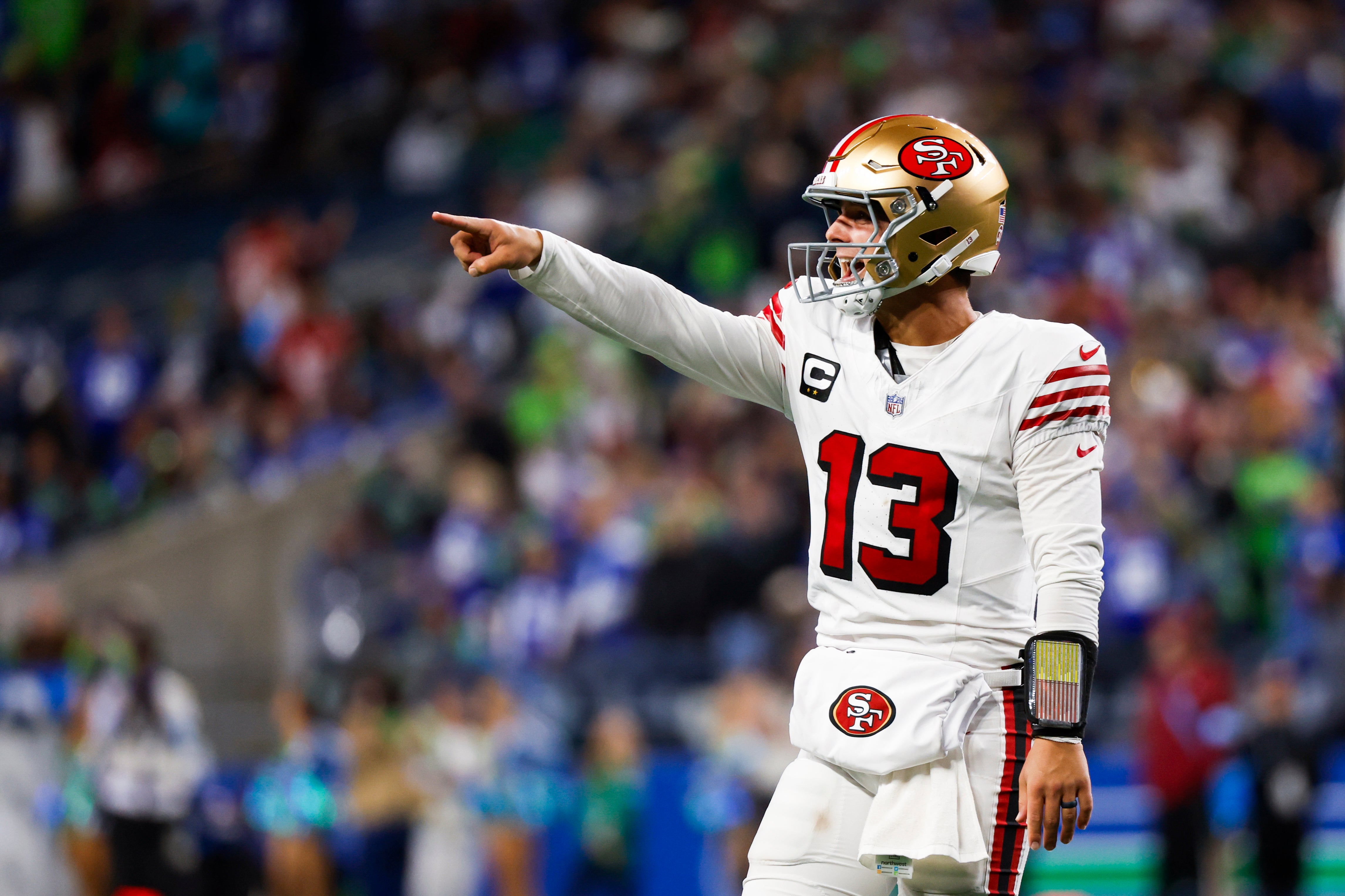 San Francisco 49ers quarterback Brock Purdy (13) celebrates after throwing a touchdown pass against the Seattle Seahawks during the fourth quarter at Lumen Field.