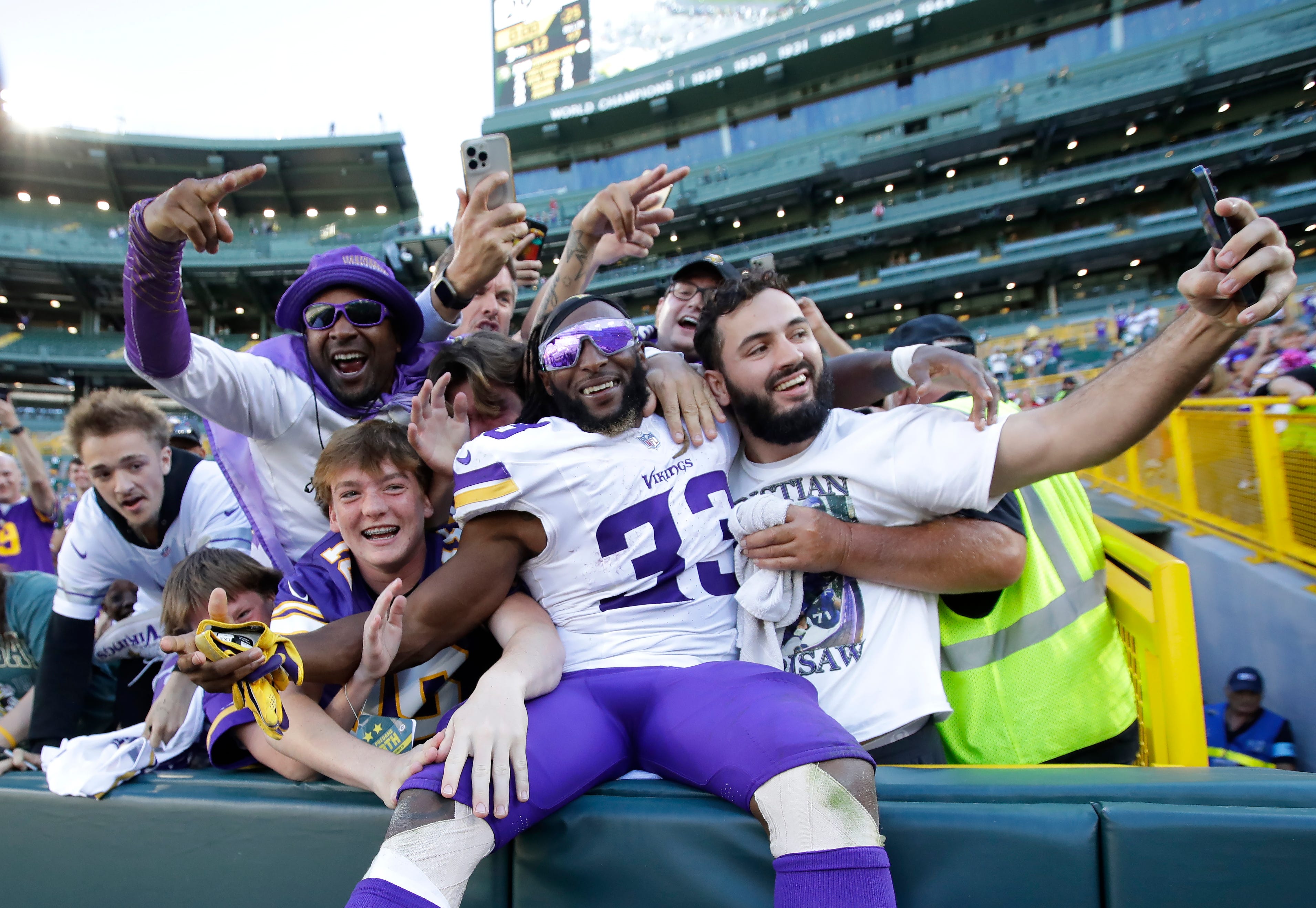Minnesota Vikings running back Aaron Jones (33) does a Lambeau Leap with fans following a 31-29 victory against the Green Bay Packers Sunday, September 29, 2024, at Lambeau Field in Green Bay, Wisconsin.