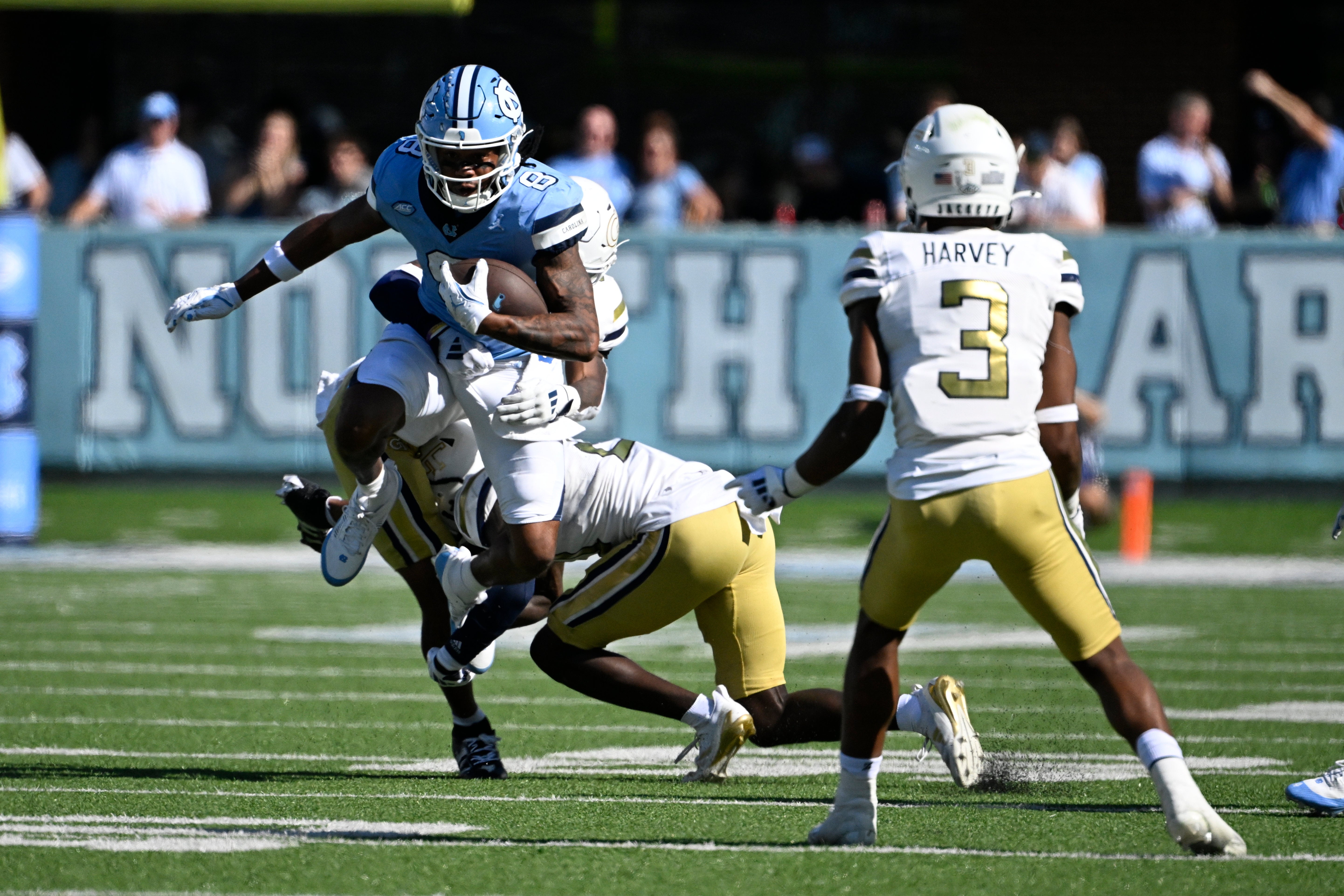 North Carolina Tar Heels wide receiver Kobe Paysour (8) with the ball as Georgia Tech Yellow Jackets defensive backs Clayton Powell-Lee (5) and Omar Daniels (21) and Ahmari Harvey (3) defend in the fourth quarter at Kenan Memorial Stadium.
