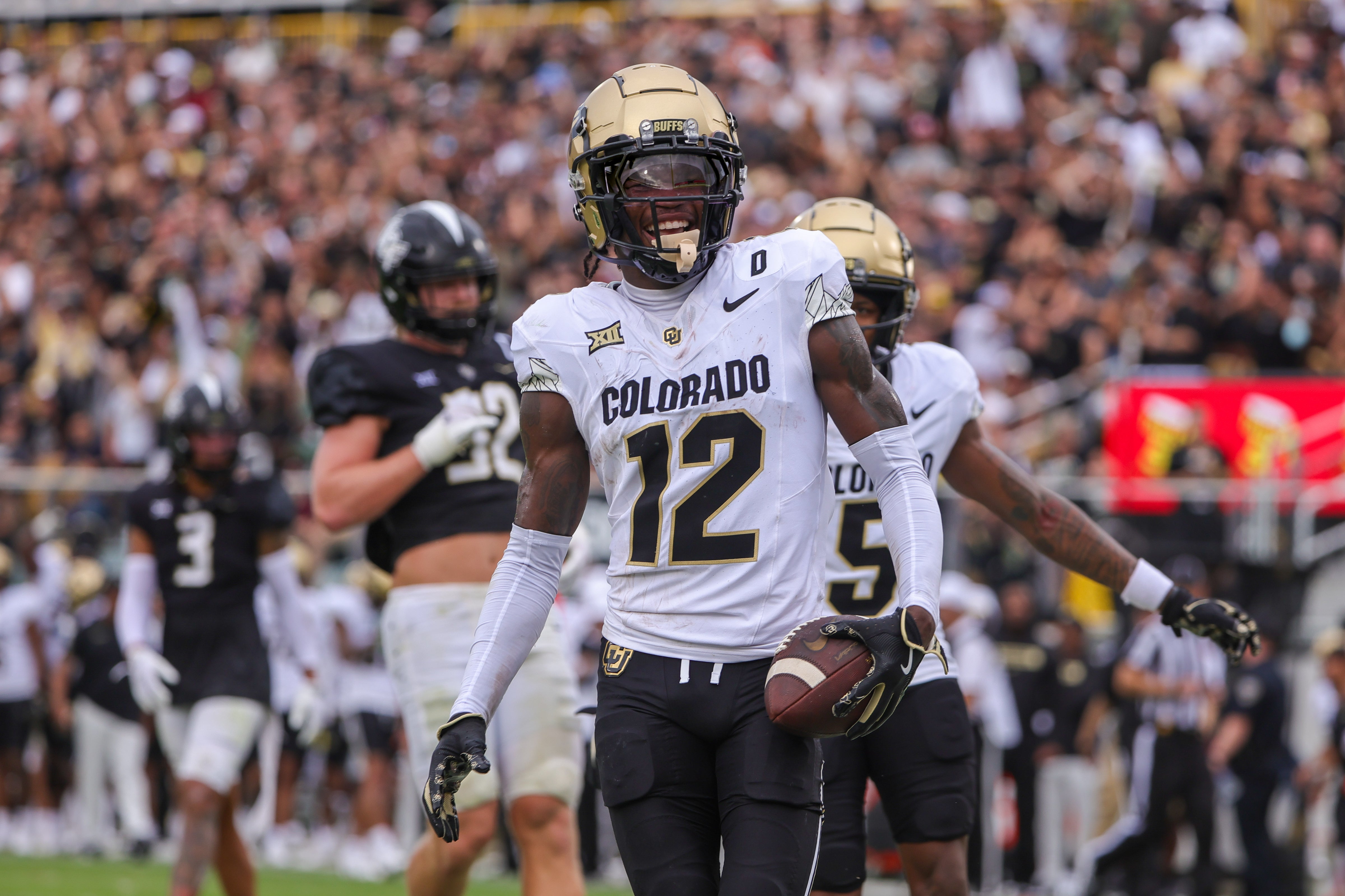 Sep 28, 2024; Orlando, Florida, USA; Colorado Buffaloes wide receiver Travis Hunter (12) scores a touchdown against the UCF Knights during the first quarter at FBC Mortgage Stadium.