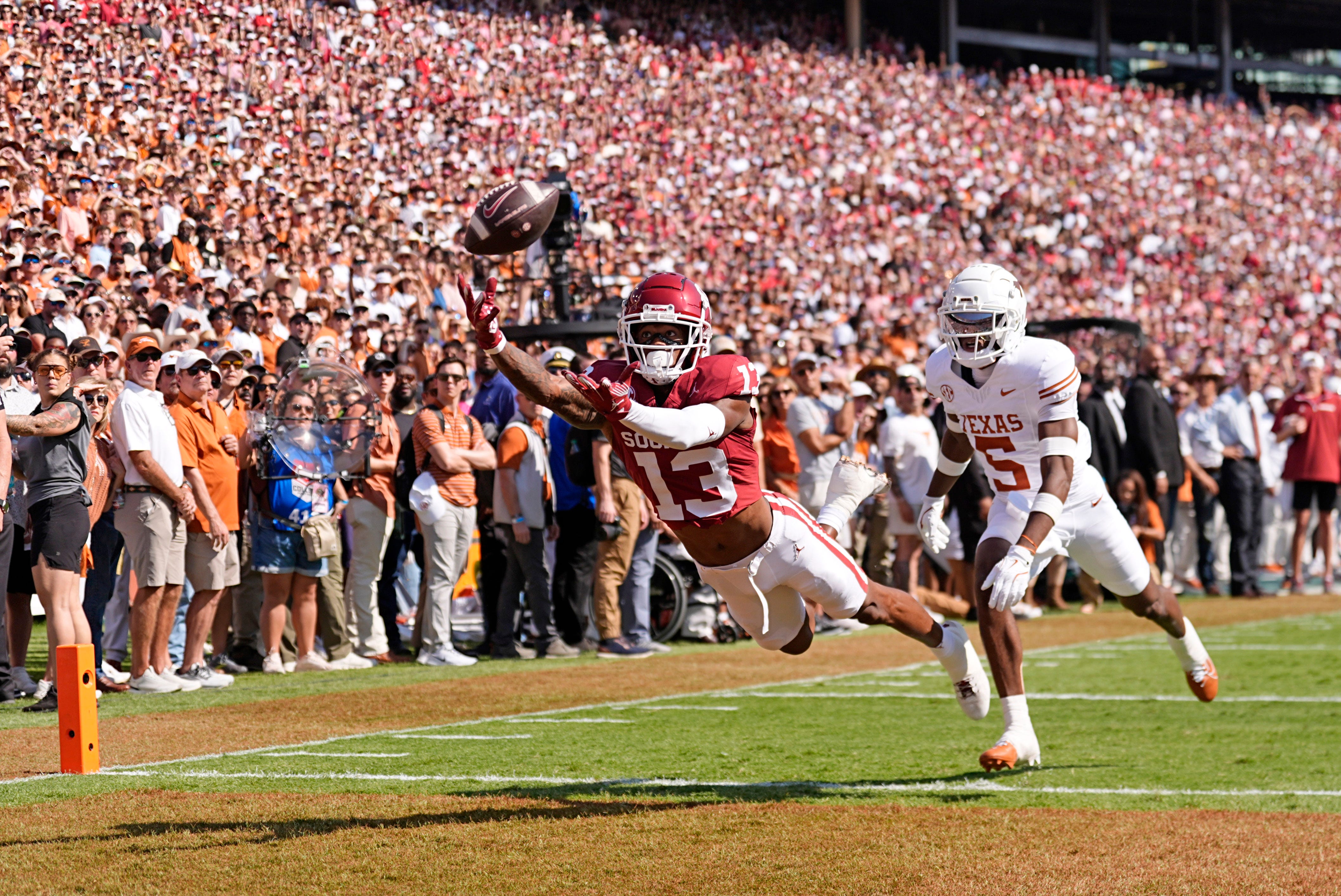 Oklahoma Sooners wide receiver J.J. Hester (13) can not make a catch as Texas Longhorns defensive back Malik Muhammad (5) defends in the first half of the Red River Rivalry college football game between the University of Oklahoma Sooners and the Texas Longhorn at the Cotton Bowl Stadium in Dallas, Texas, Saturday, Oct., 12, 2024.