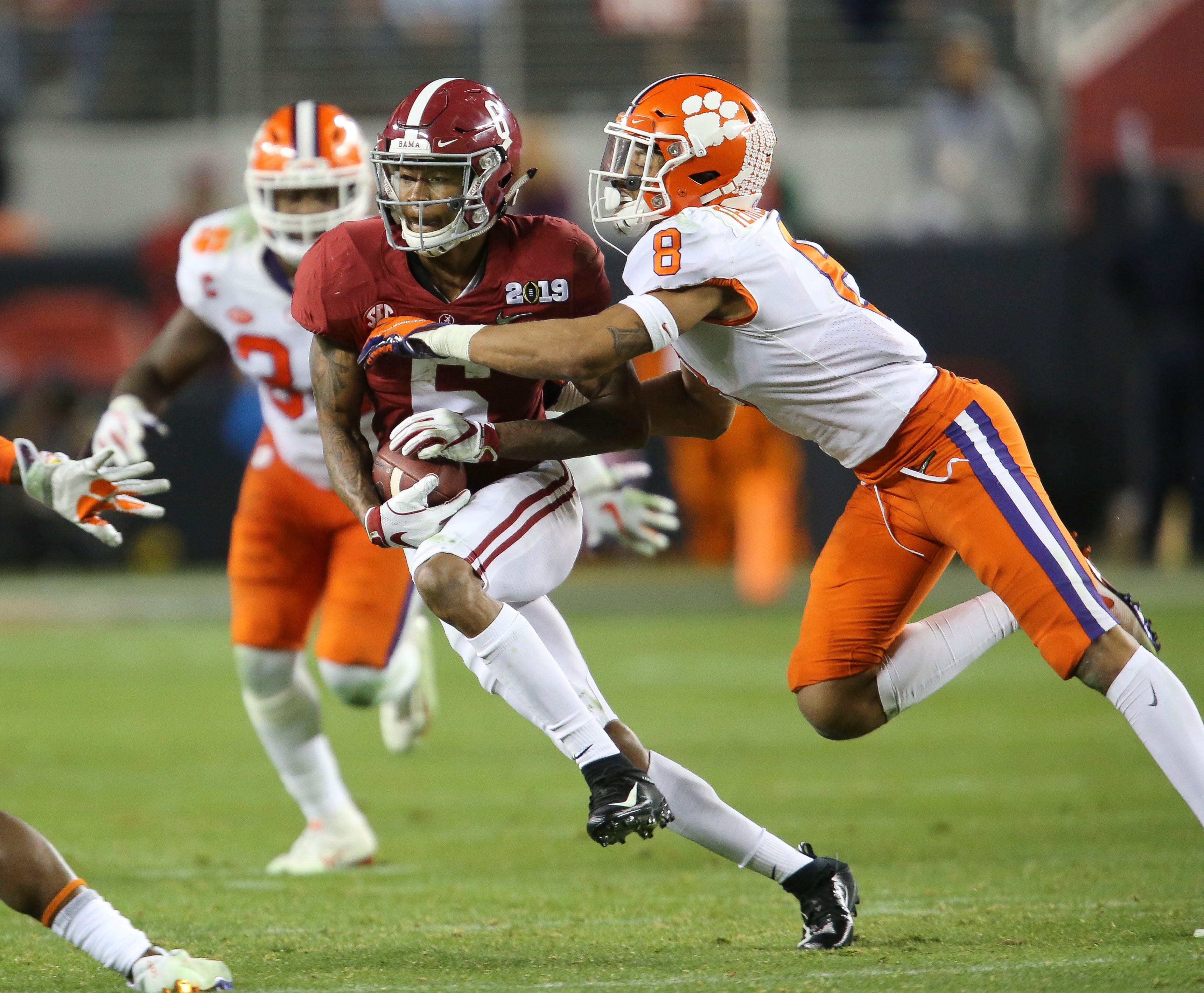 Clemson cornerback A.J. Terrell (8) brings down Alabama wide receiver DeVonta Smith (6). Clemson defeated Alabama 44-16 in Levi's Stadium in Santa Clara, California Monday, Jan. 7, 2019 to win the College Football Playoff National Championship game. [Staff Photo/Gary Cosby Jr.] Cfp National Championship Alabama Vs Clemson