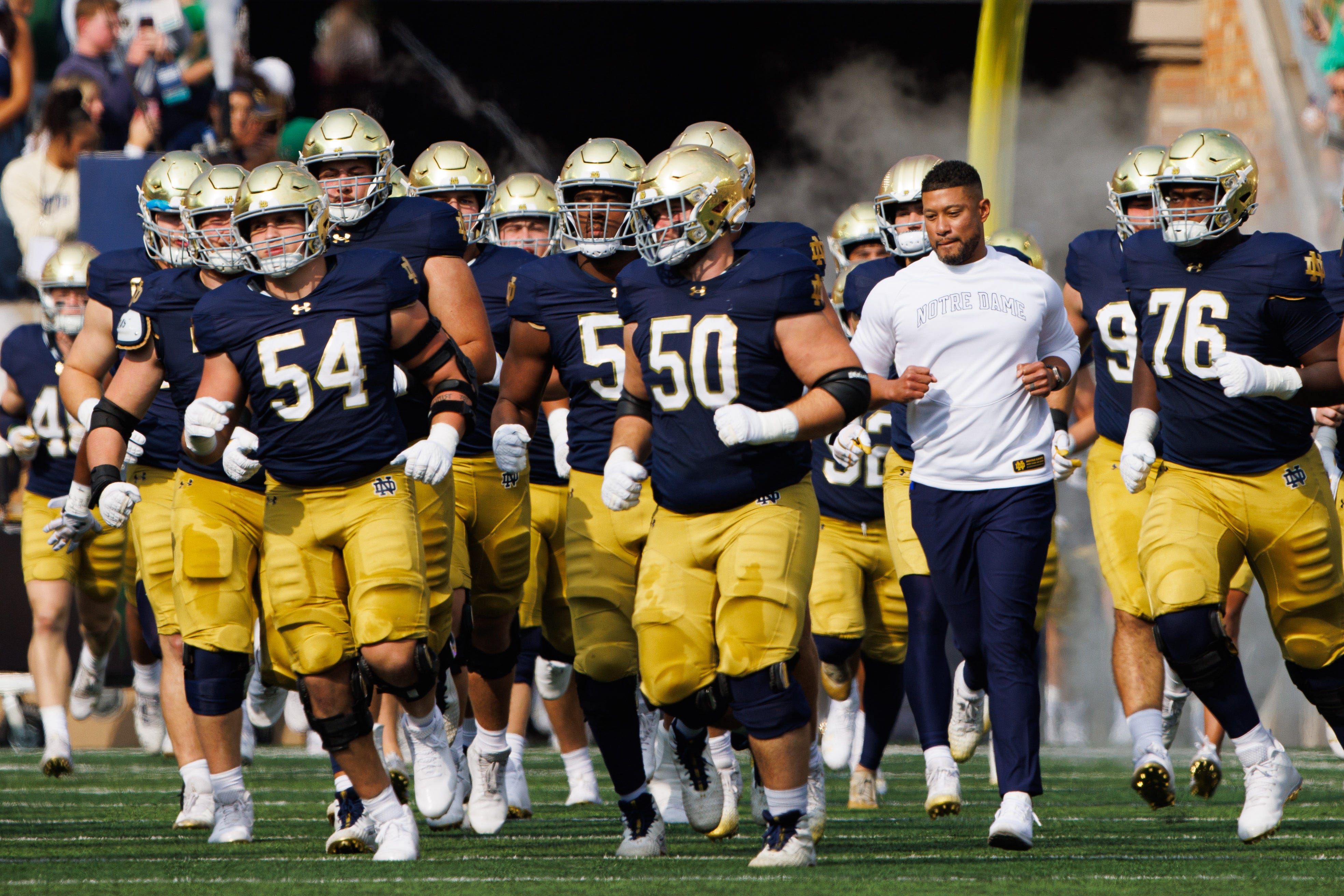 Notre Dame head coach Marcus Freeman runs out with his team before a NCAA college football game between Notre Dame and Stanford at Notre Dame Stadium on Saturday, Oct. 12, 2024, in South Bend.