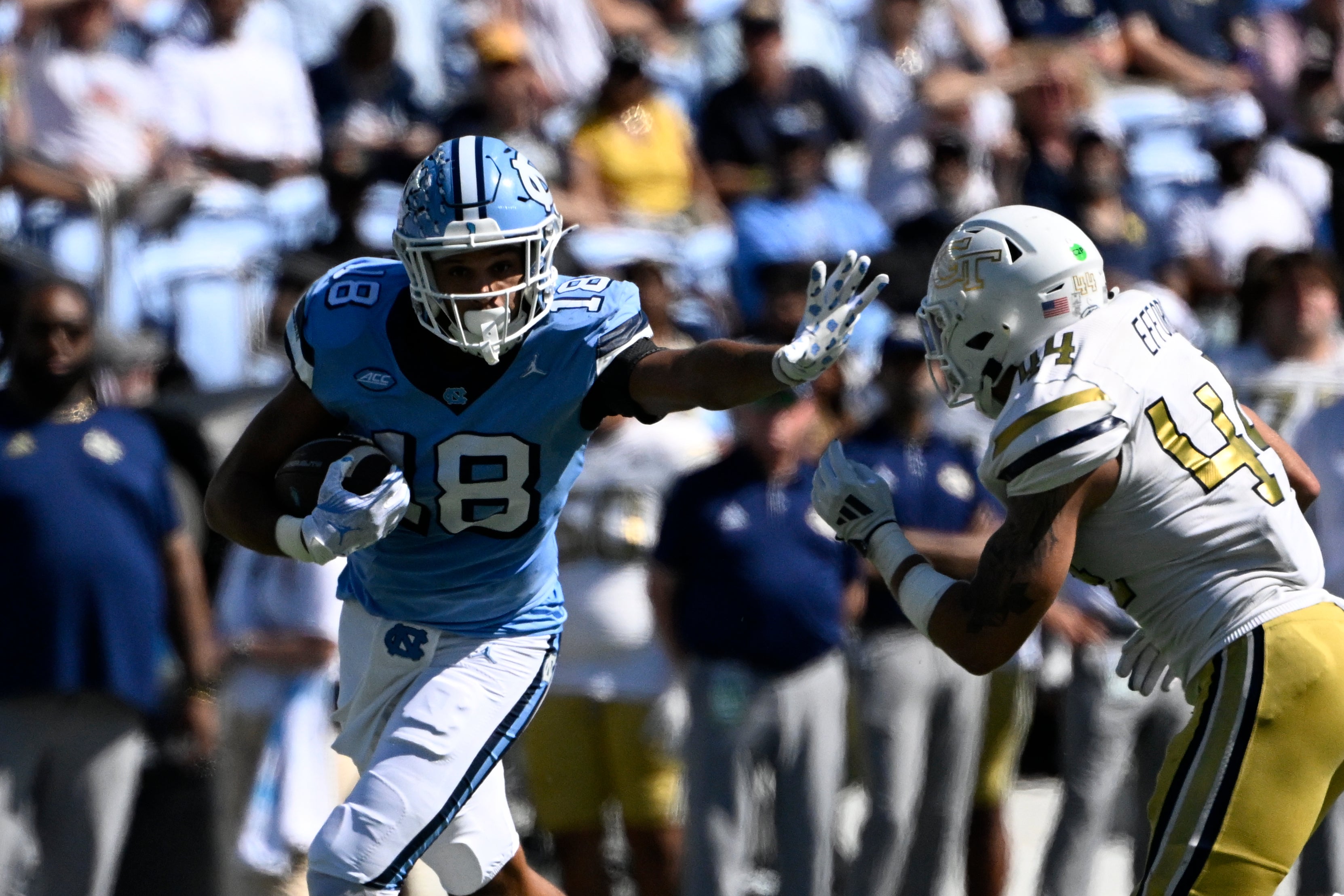 North Carolina Tar Heels tight end Bryson Nesbit (18) with the ball as Georgia Tech Yellow Jackets linebacker Kyle Efford (44) defends in the second quarter at Kenan Memorial Stadium.