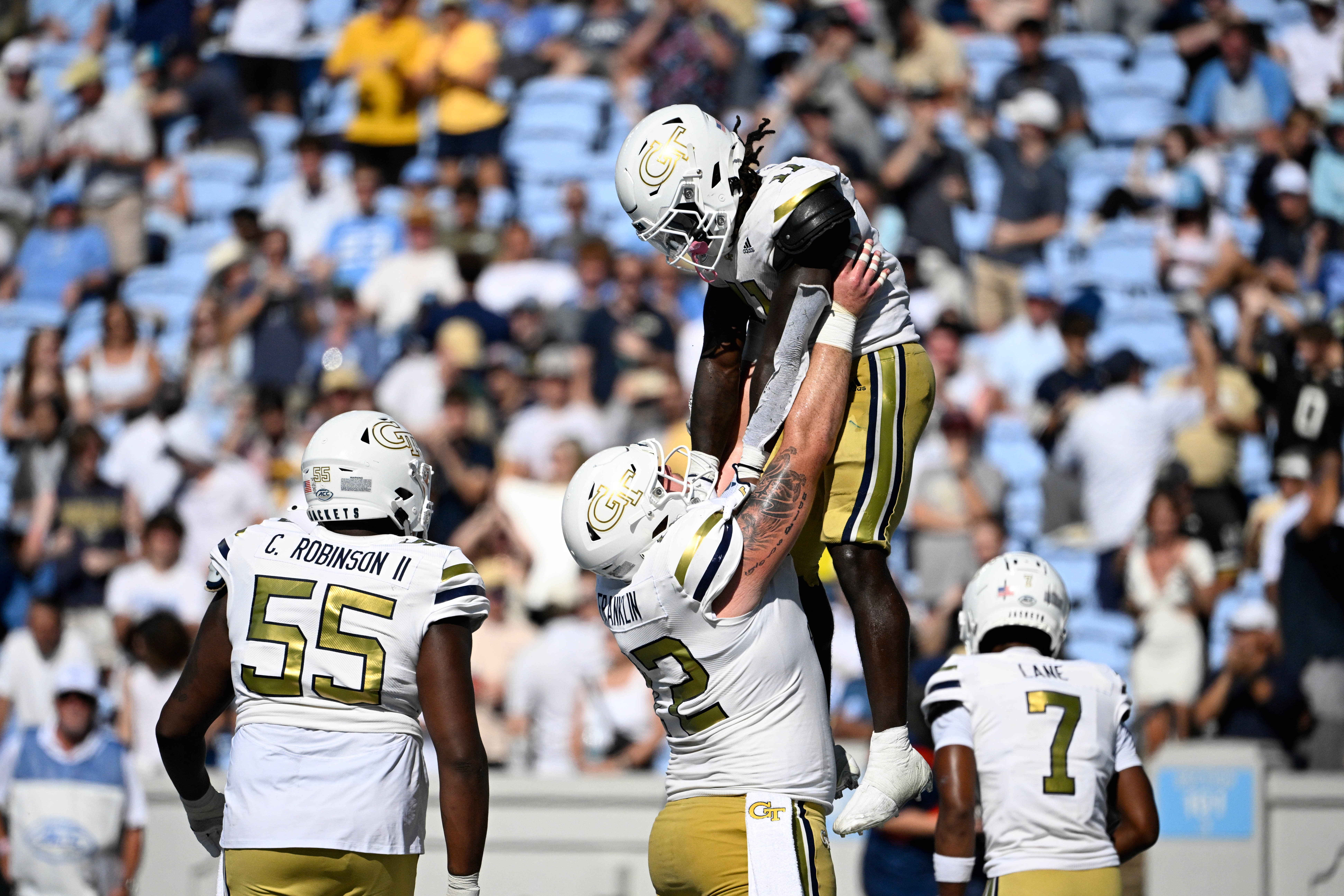 Georgia Tech Yellow Jackets running back Jamal Haynes (11) is hoisted in the air after scoring a touchdown in the fourth quarter at Kenan Memorial Stadium.