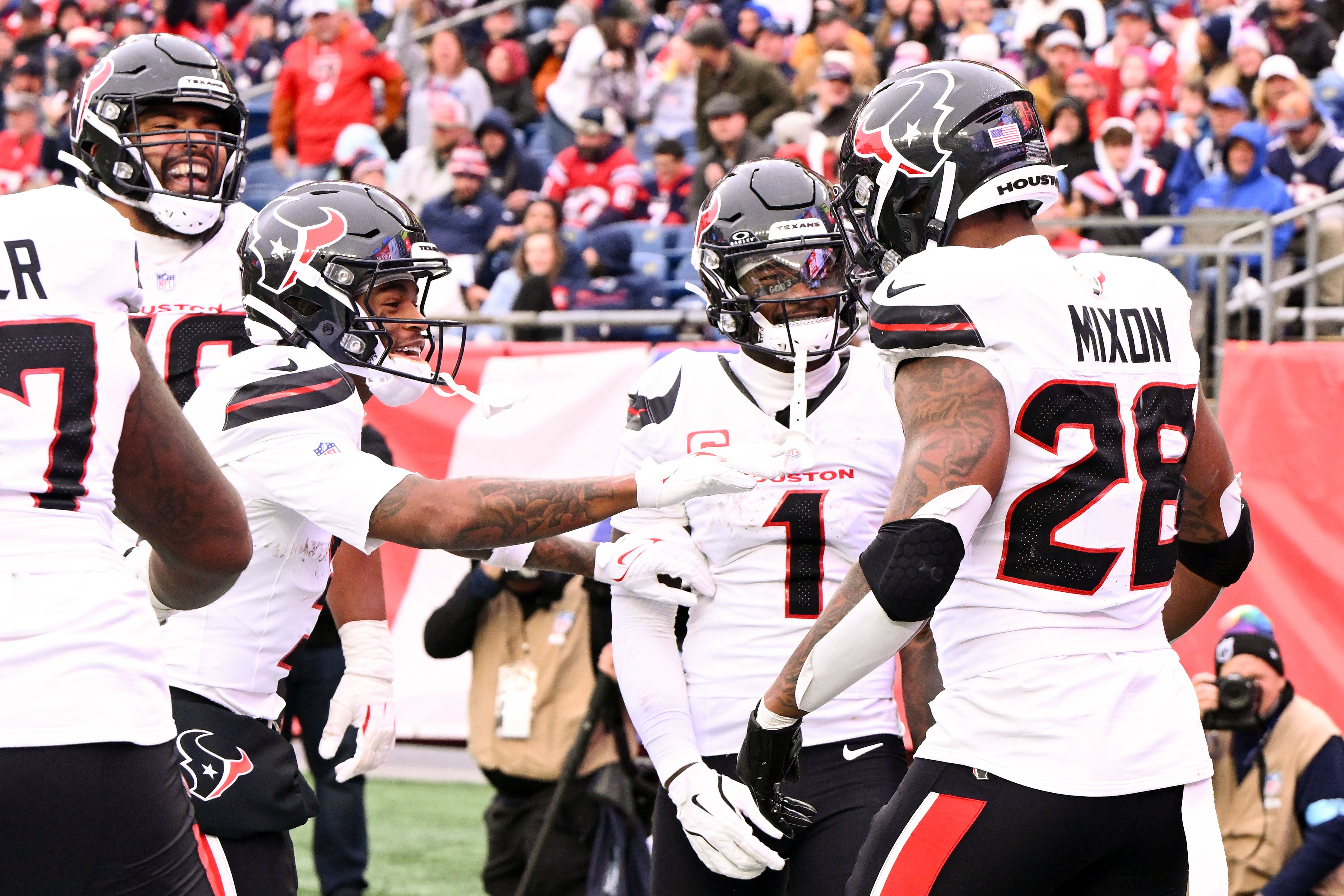 Oct 13, 2024; Foxborough, Massachusetts, USA; Houston Texans running back Joe Mixon (28) celebrates with wide receiver Stefon Diggs (1) after scoring a touchdown against the New England Patriots during the second half at Gillette Stadium.
