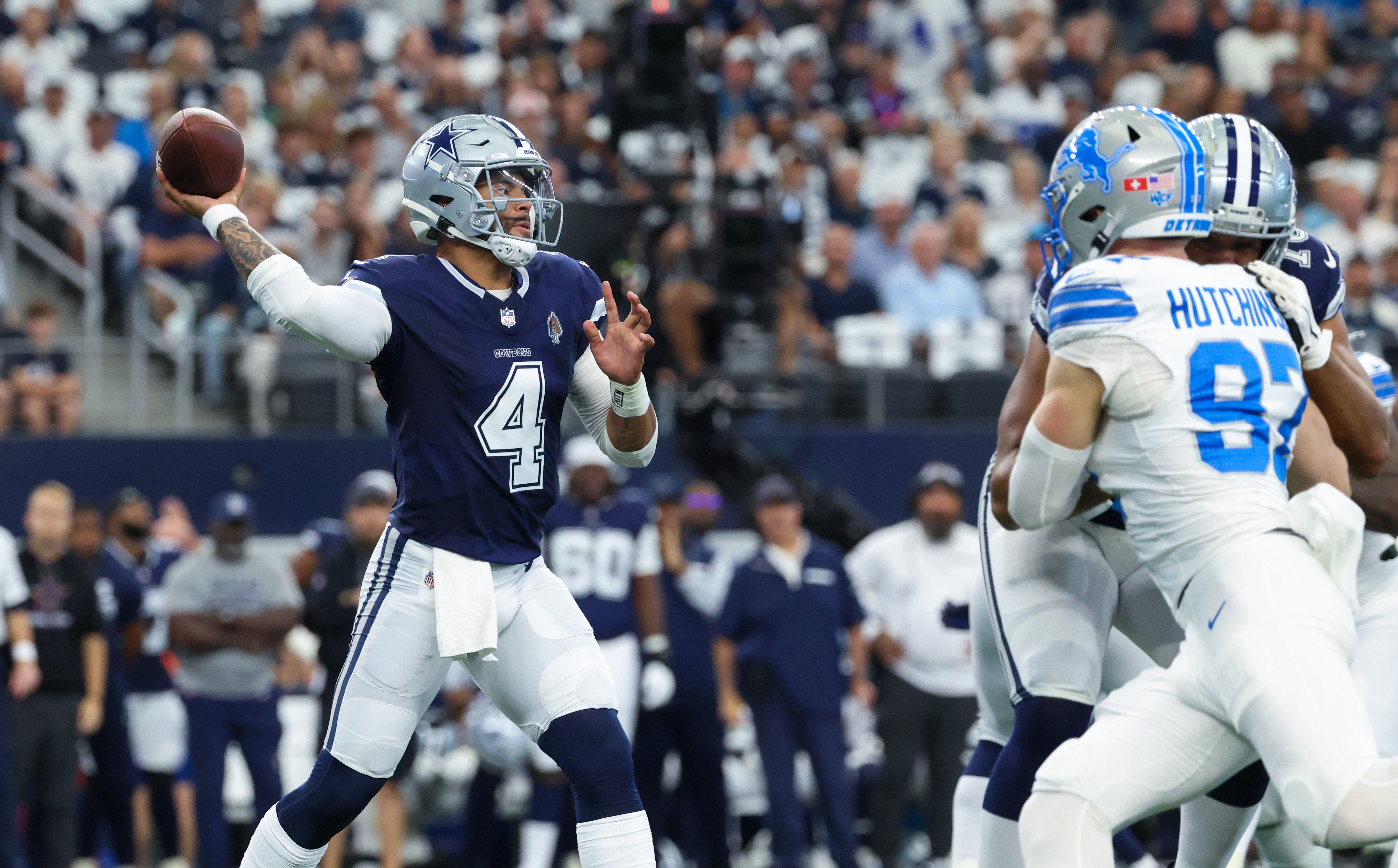 Dallas Cowboys quarterback Dak Prescott (4) throws as Detroit Lions defensive end Aidan Hutchinson (97) rushes during the first quarter at AT&T Stadium.