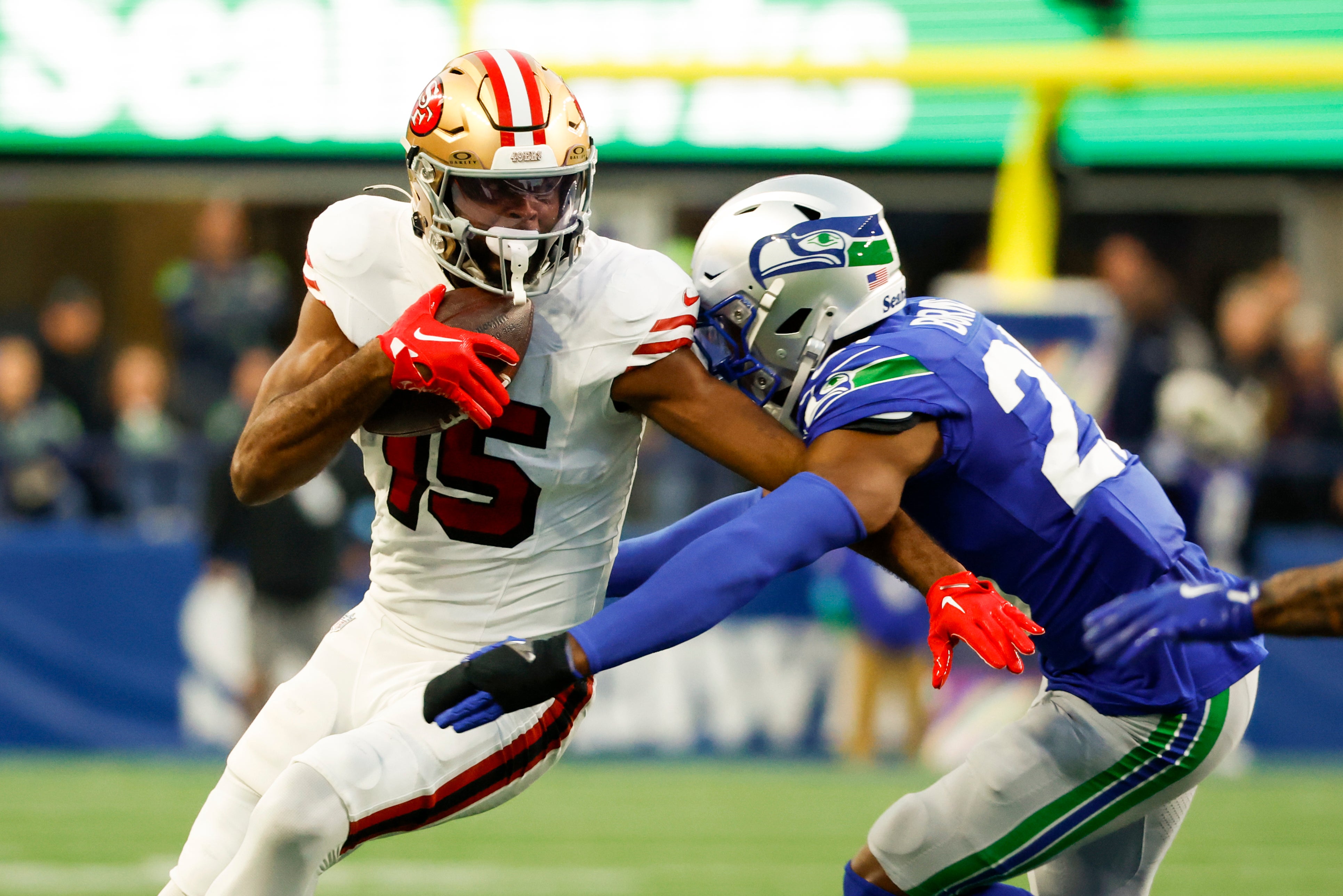 49ers wide receiver Jauan Jennings runs for yards after the catch against Seahawks cornerback Tre Brown during the second quarter at Lumen Field.