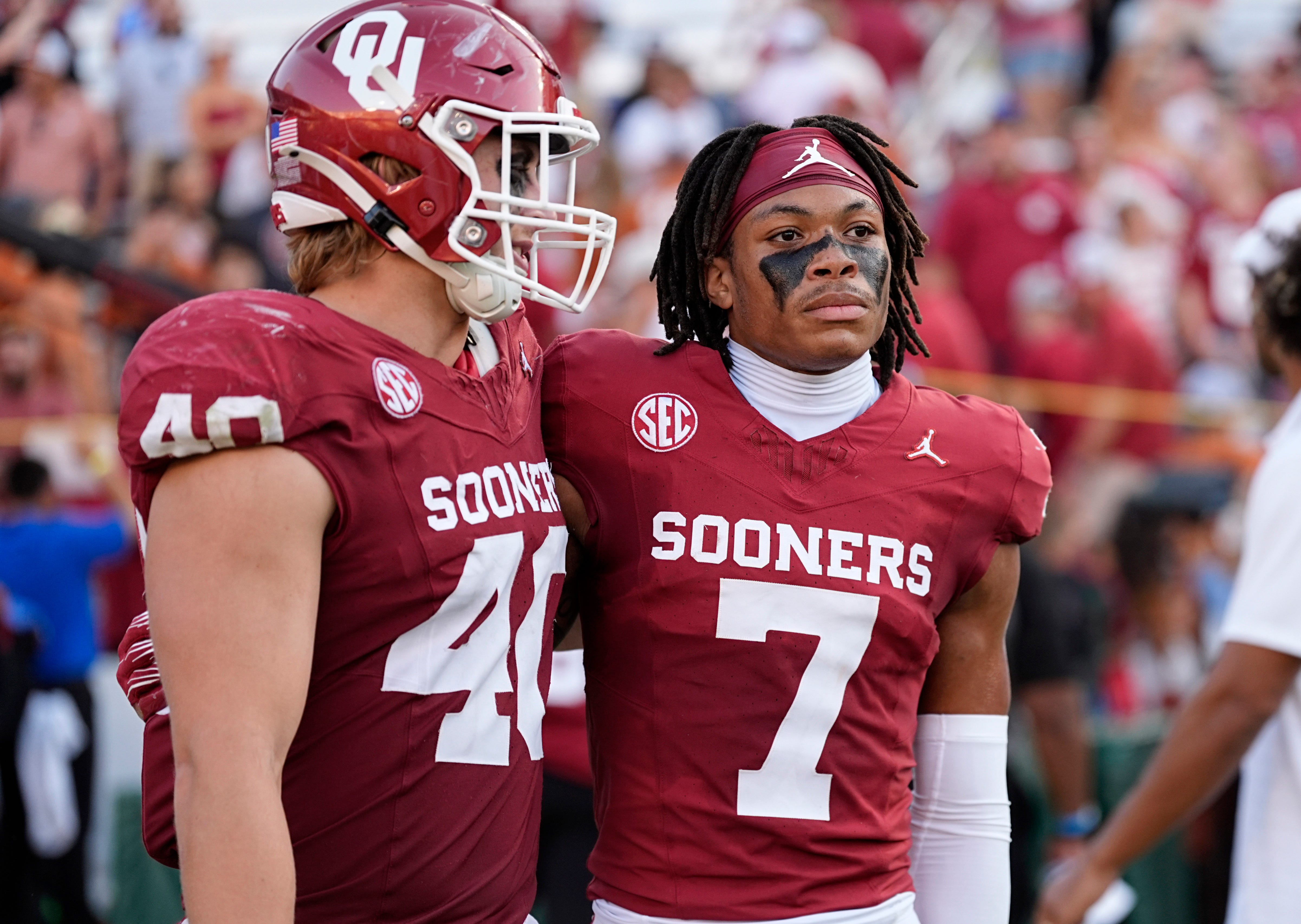 Oklahoma Sooners defensive lineman Ethan Downs (40) and Zion Kearney (7) walk off the field following the Red River Rivalry college football game between the University of Oklahoma Sooners and the Texas Longhorn at the Cotton Bowl Stadium in Dallas, Texas, Saturday, Oct., 12, 2024.