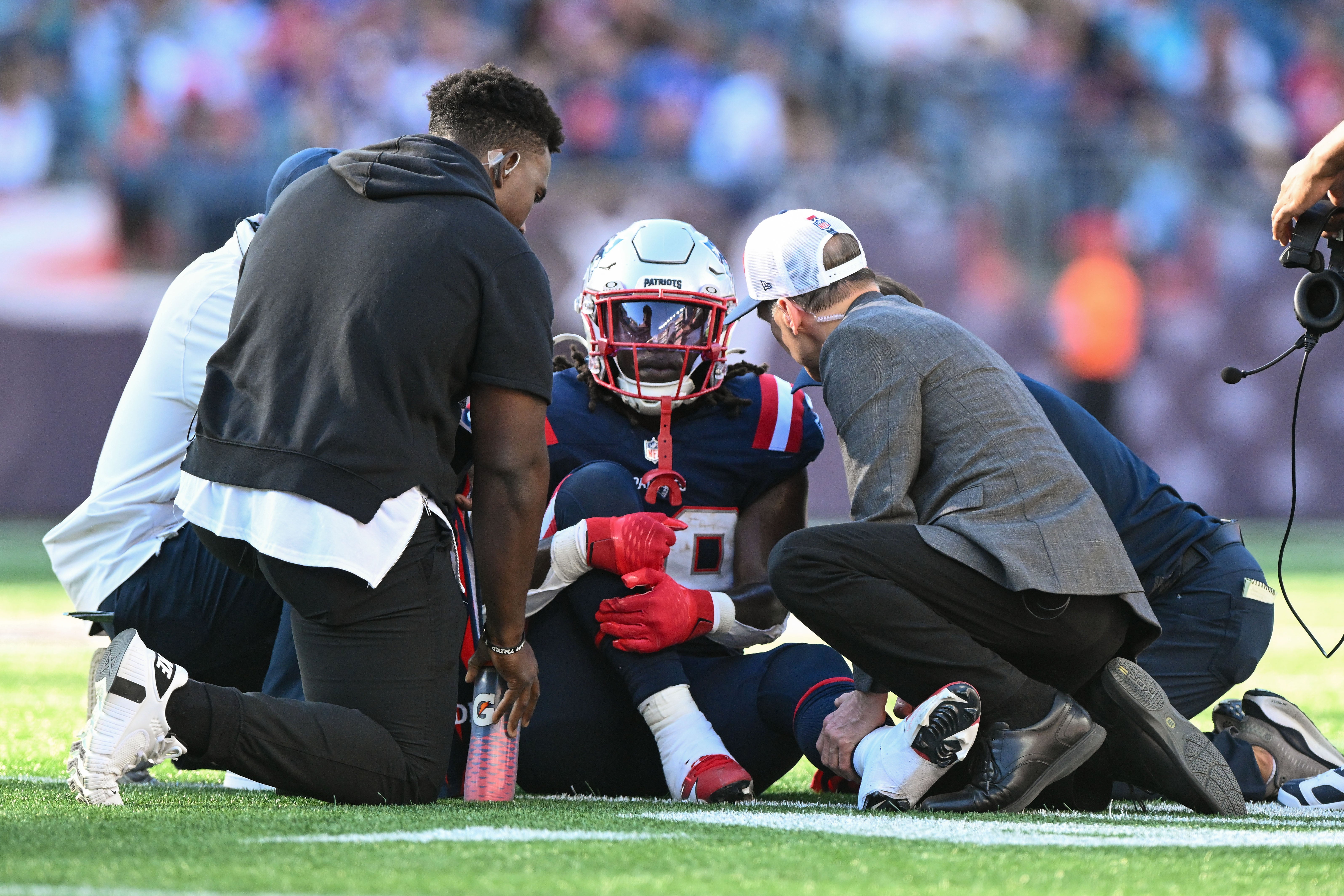 Oct 6, 2024; Foxborough, Massachusetts, USA; New England Patriots running back Rhamondre Stevenson (38) is helped by medical staff during the second half of a game against the Miami Dolphins at Gillette Stadium.