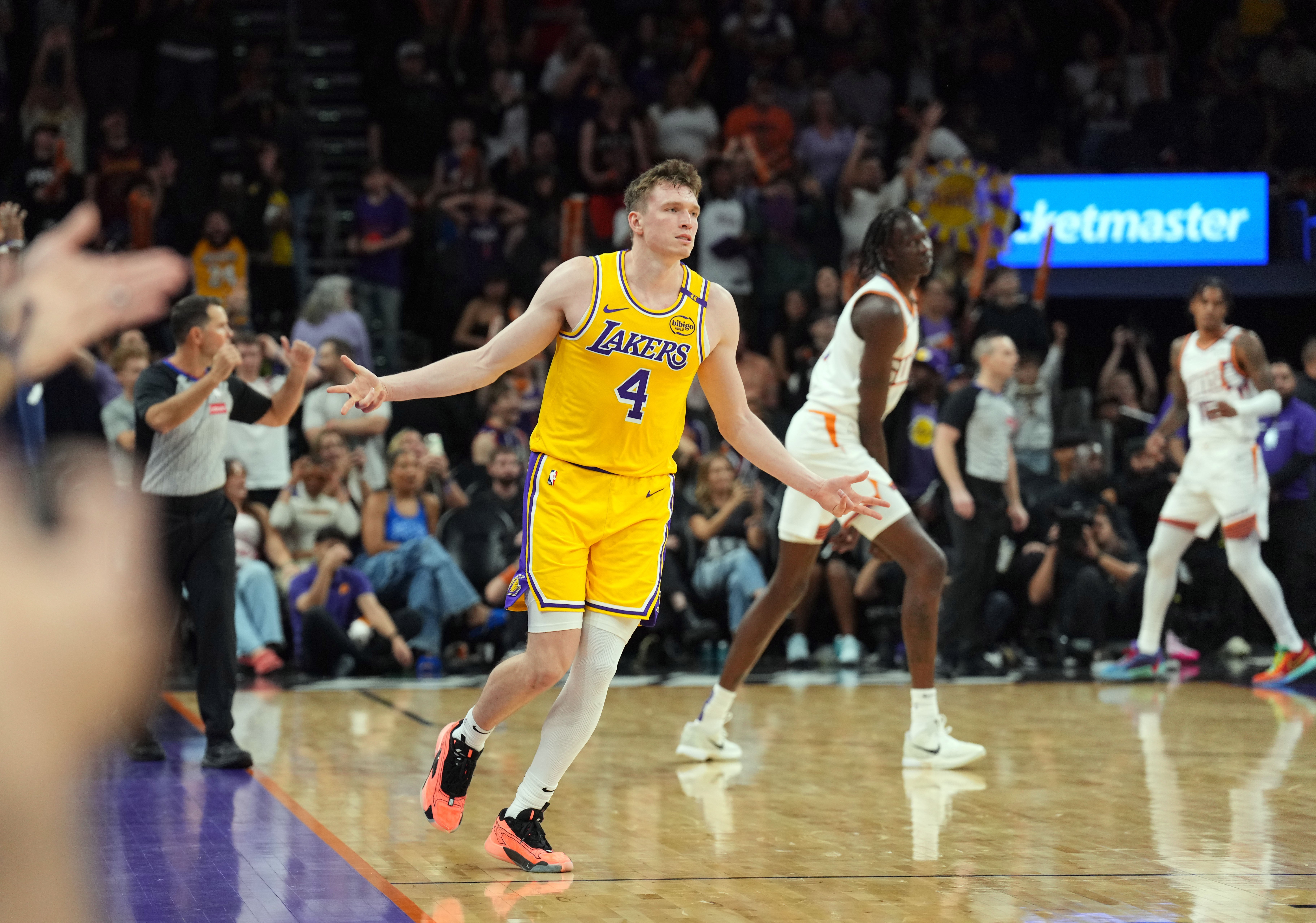 Oct 17, 2024; Phoenix, Arizona, USA; Los Angeles Lakers guard Dalton Knecht (4) reacts after making a three point basket against the Phoenix Suns during the overtime period at Footprint Center.