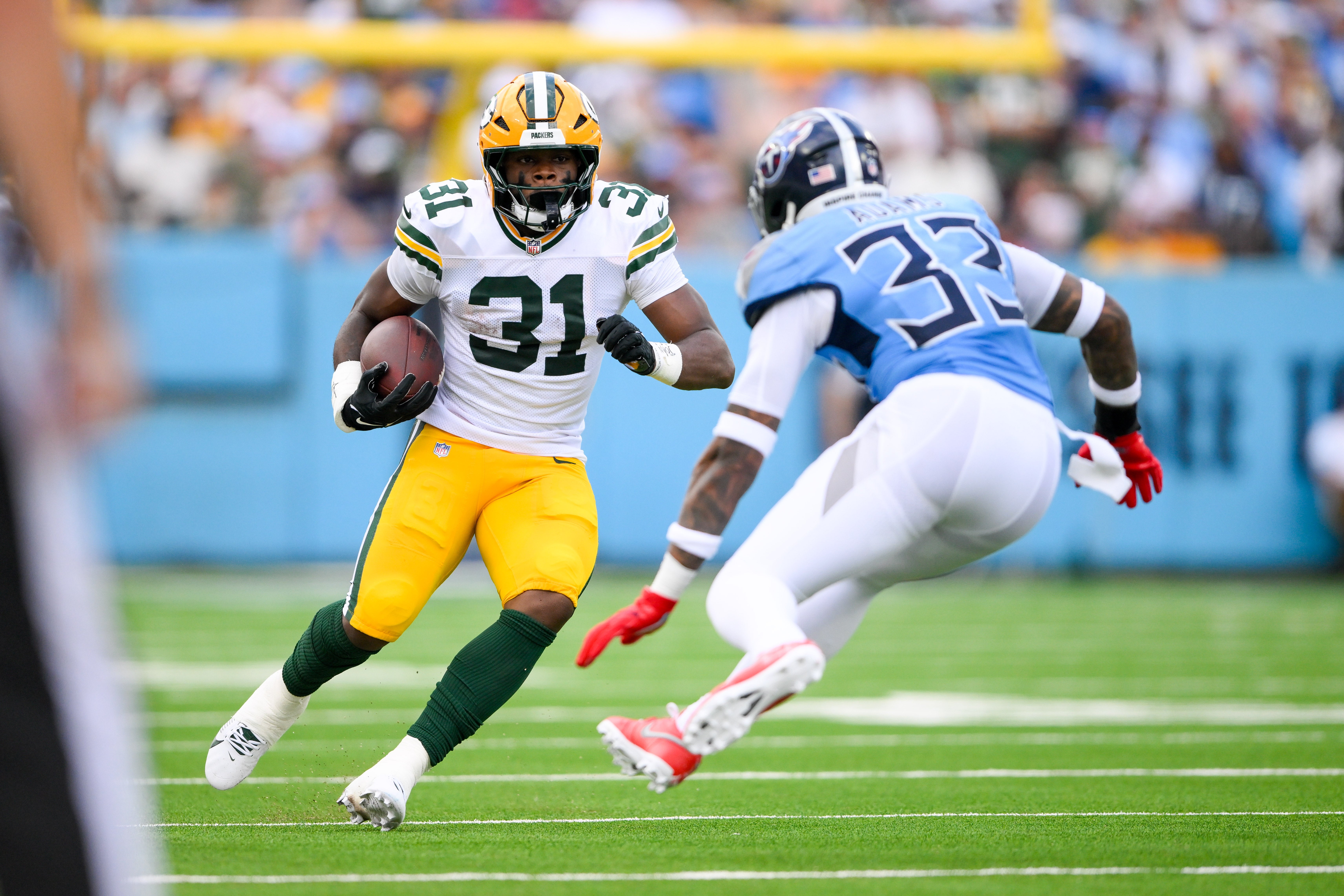 Sep 22, 2024; Nashville, Tennessee, USA; Tennessee Titans safety Jamal Adams (33) tackles Green Bay Packers running back Emanuel Wilson (31) during the first half at Nissan Stadium. Mandatory Credit: Steve Roberts-Imagn Images