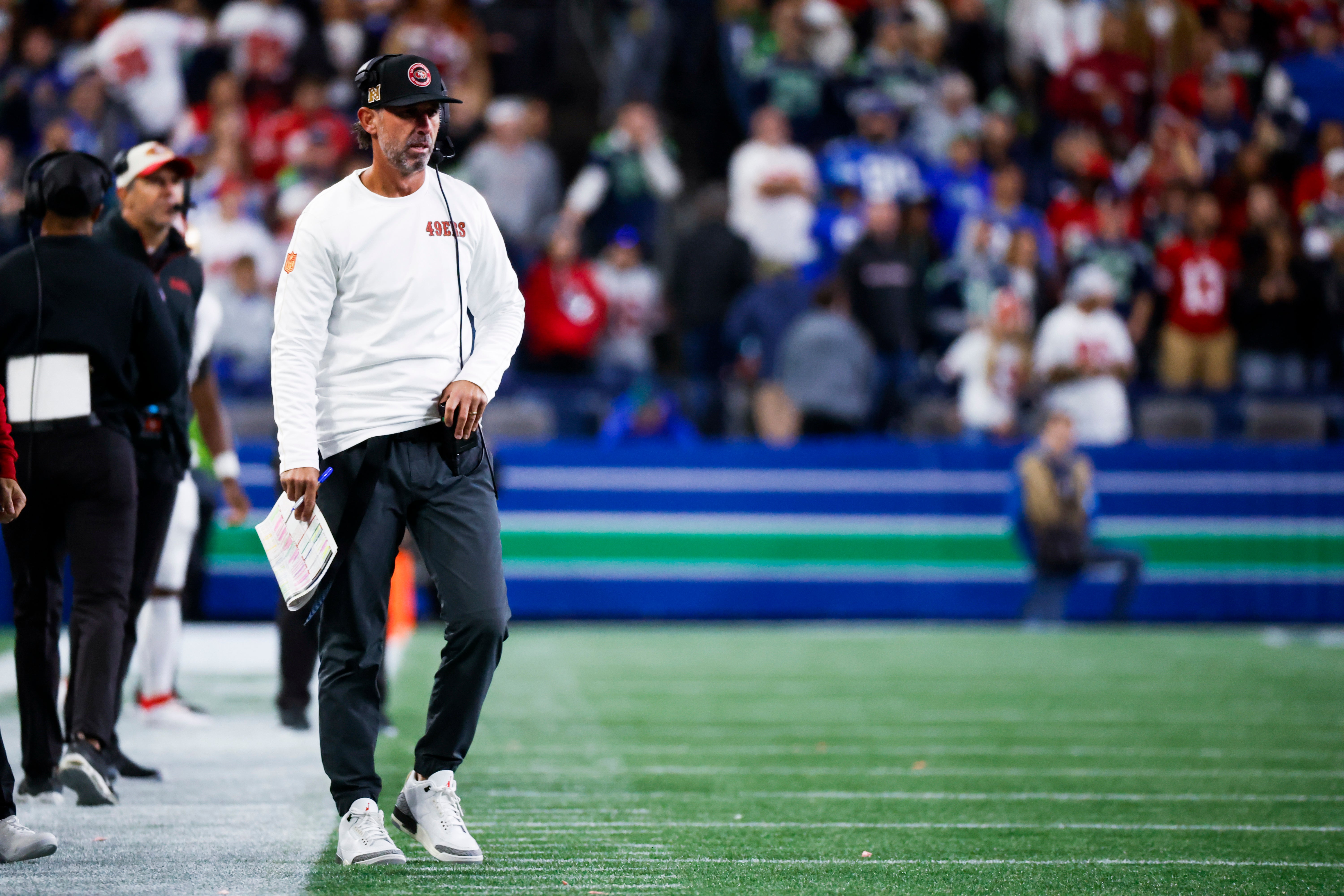 San Francisco 49ers head coach Kyle Shanahan stands on the sideline during the fourth quarter against the Seattle Seahawks at Lumen Field.