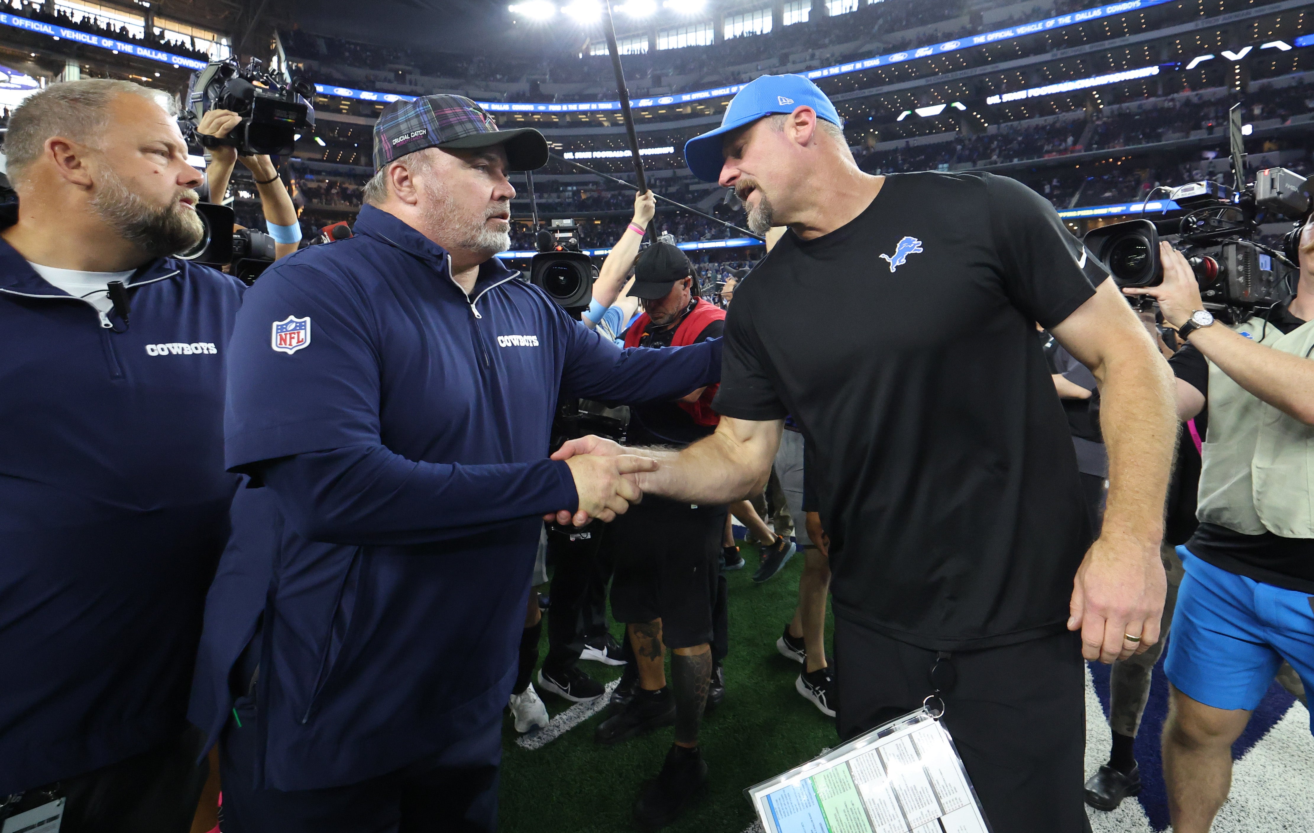 Dallas Cowboys head coach Mike McCarthy shakes hands with Detroit Lions head coach Dan Campbell after the game at AT&T Stadium.