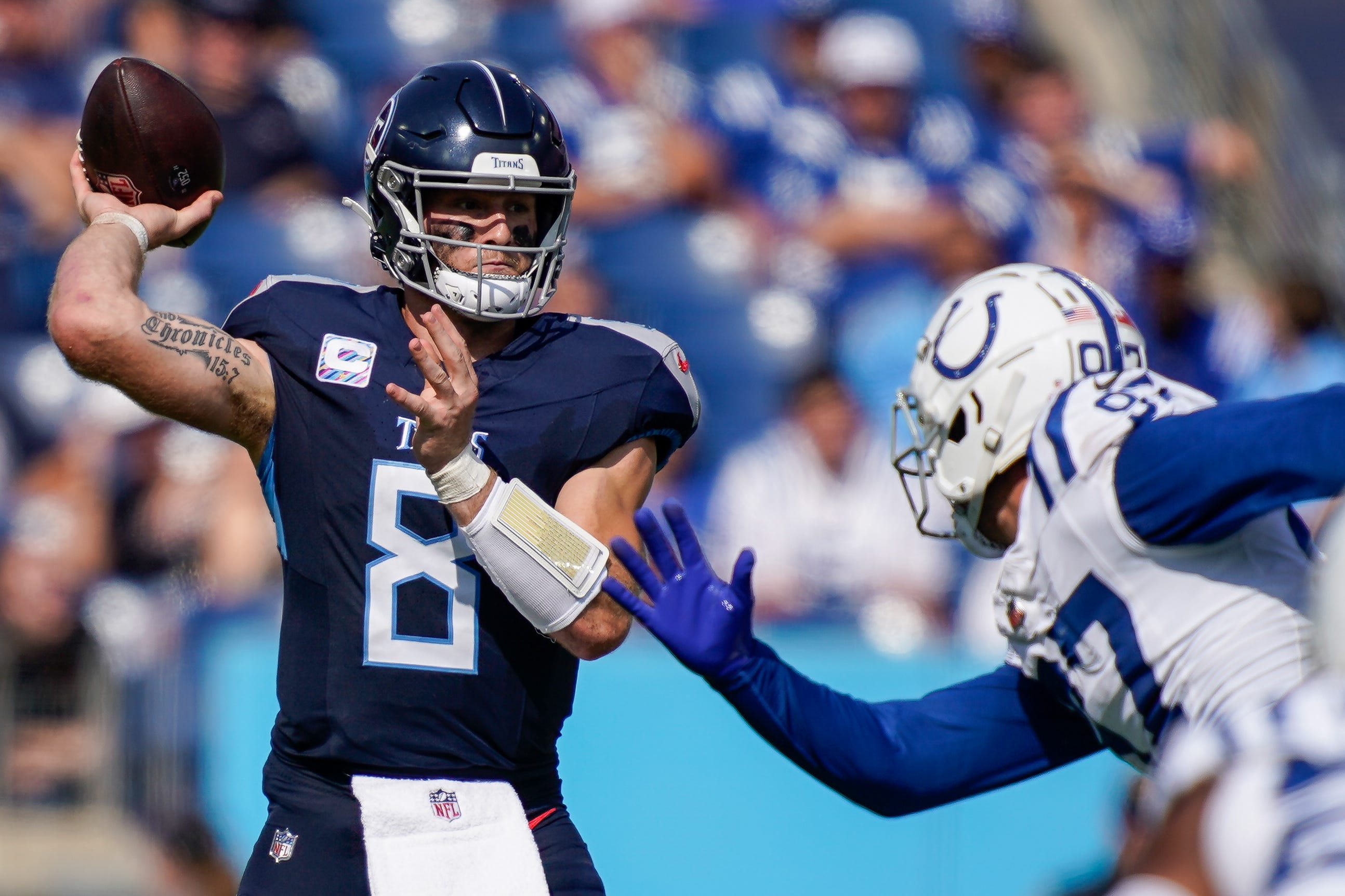 Tennessee Titans quarterback Will Levis (8) throws the ball under pressure from Indianapolis Colts defensive end Laiatu Latu (97) during the third quarter at Nissan Stadium in Nashville, Tenn., Sunday, Oct. 13, 2024.