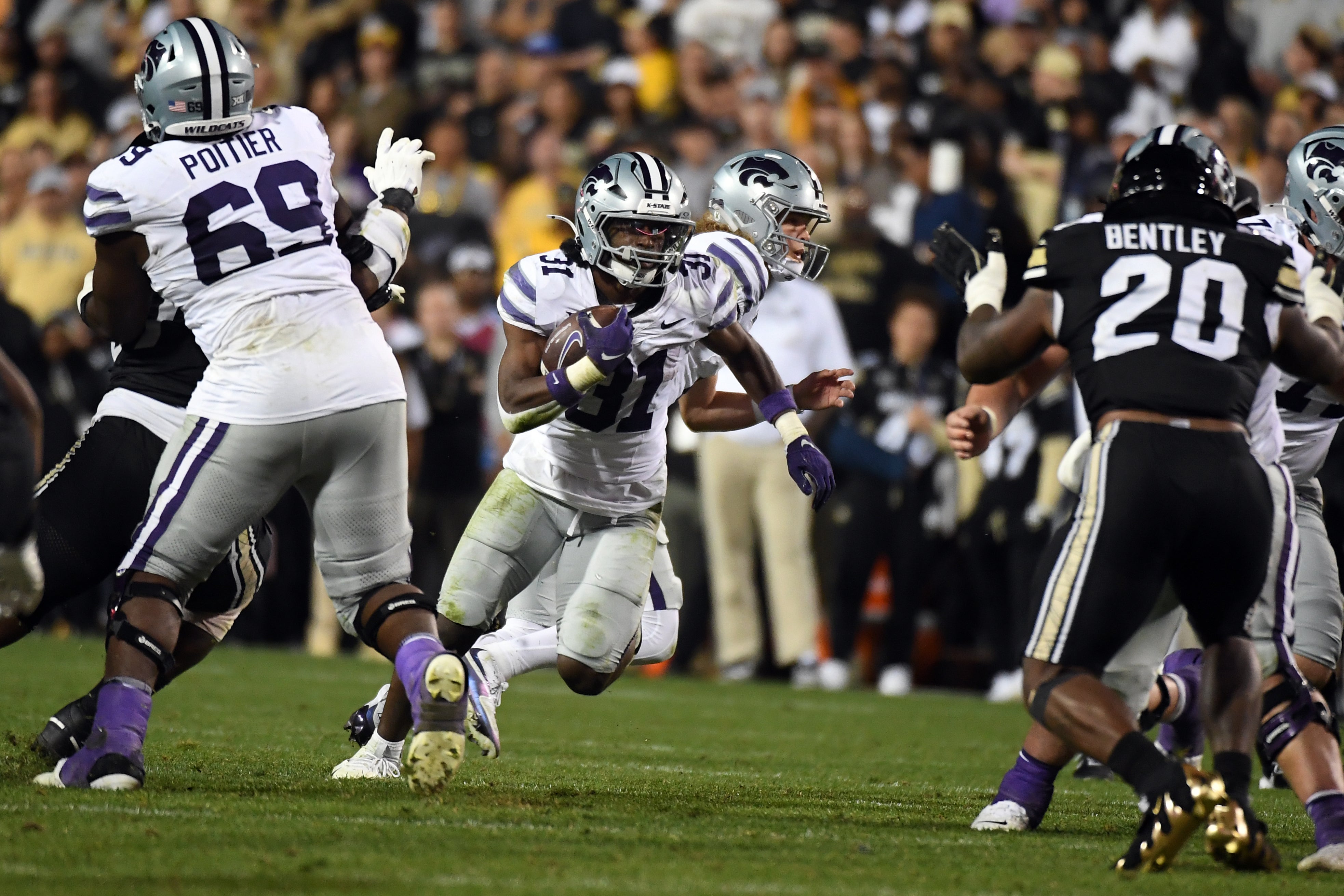 Kansas State Wildcats running back DJ Giddens (31) runs for a short gain during the second half against the Colorado Buffaloes at Folsom Field.