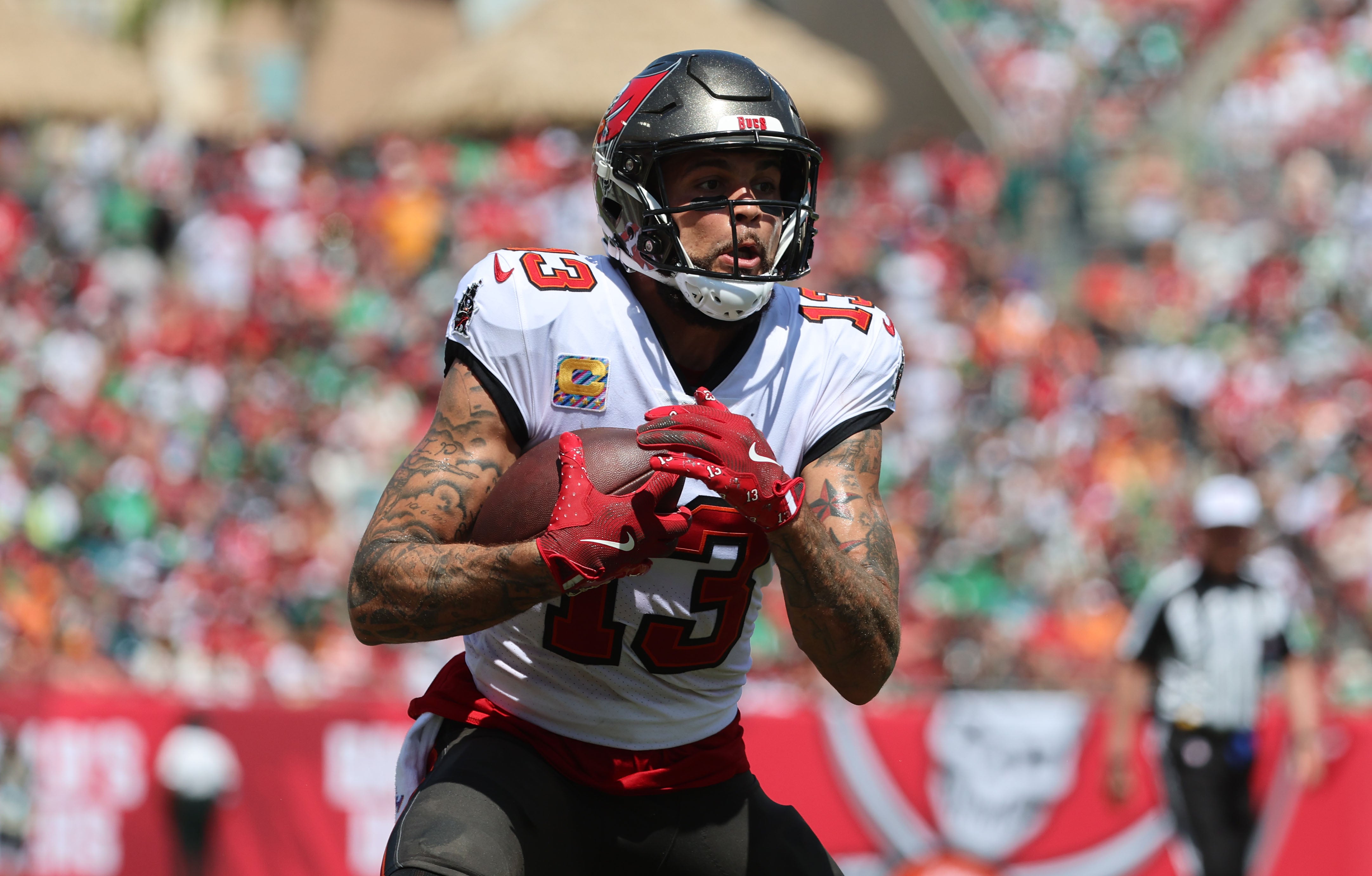 Sep 29, 2024; Tampa, Florida, USA; Tampa Bay Buccaneers wide receiver Mike Evans (13) runs with the ball against the Philadelphia Eagles during the first half at Raymond James Stadium.