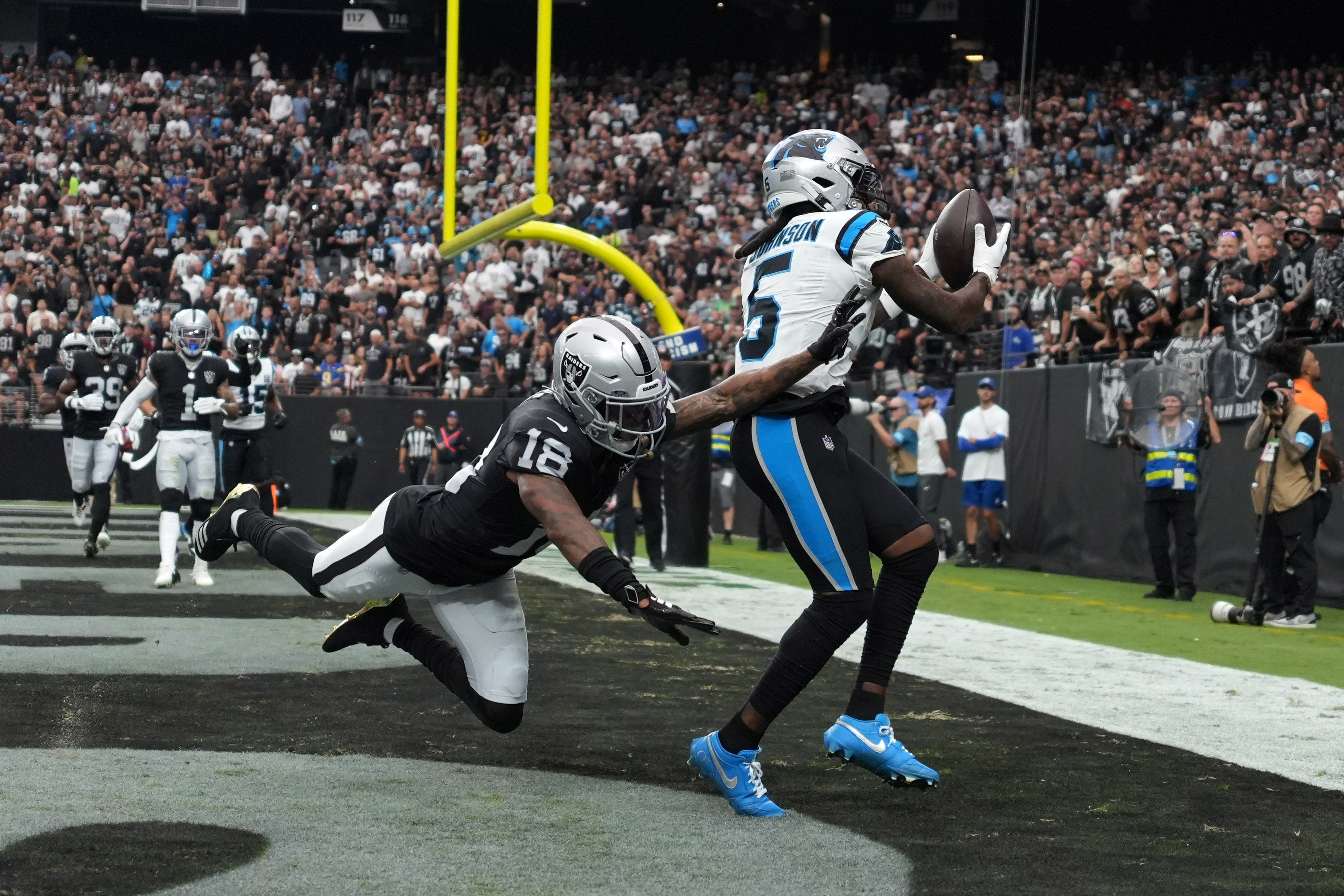 Sep 22, 2024; Paradise, Nevada, USA; Carolina Panthers wide receiver Diontae Johnson (5) catches a 5-yard touchdown pass against Las Vegas Raiders cornerback Jack Jones (18) in the first half at Allegiant Stadium.