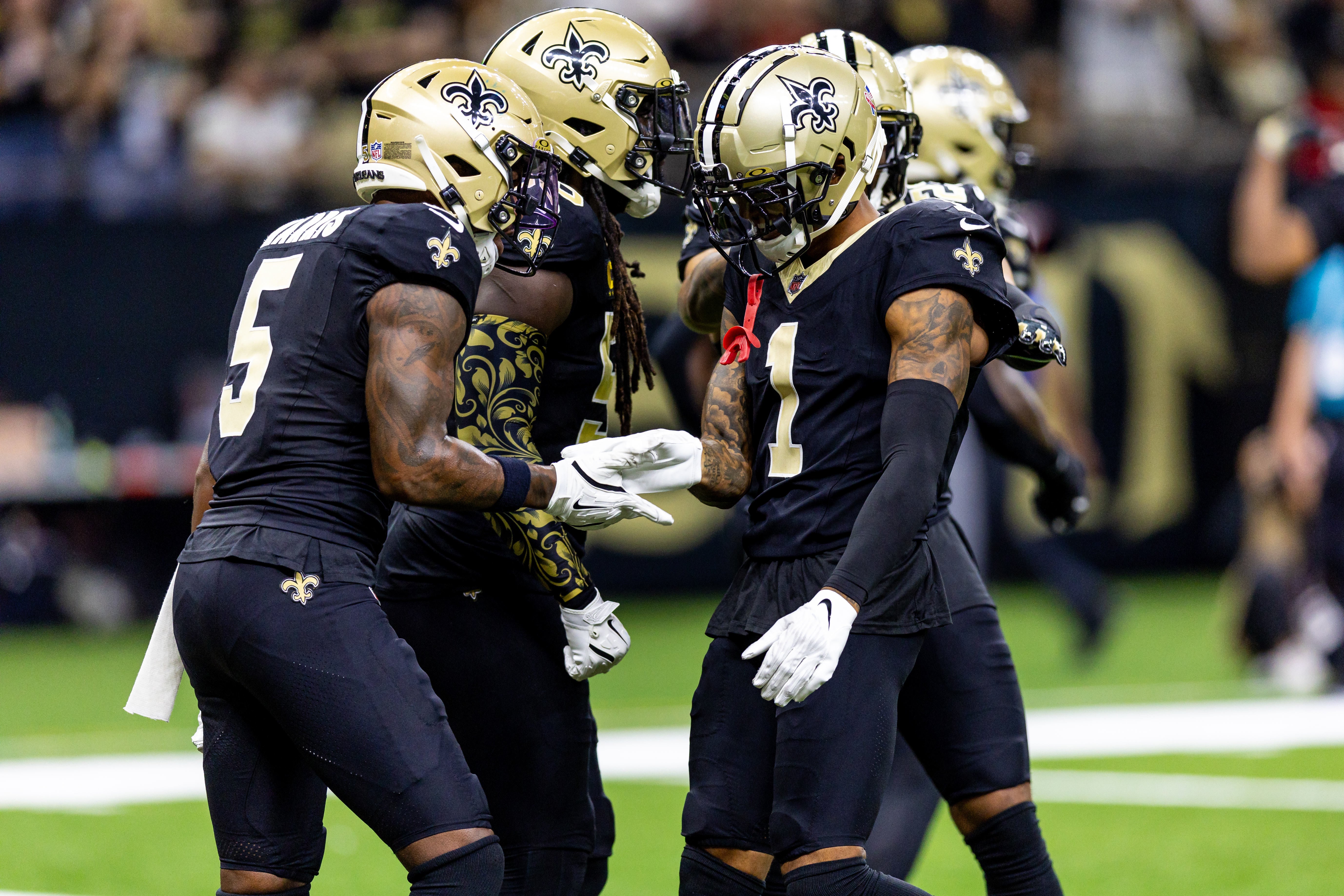 Sep 8, 2024; New Orleans, Louisiana, USA; New Orleans Saints cornerback Alontae Taylor (1) celebrates a sack against Carolina Panthers quarterback Bryce Young (9) during the first half at Caesars Superdome.