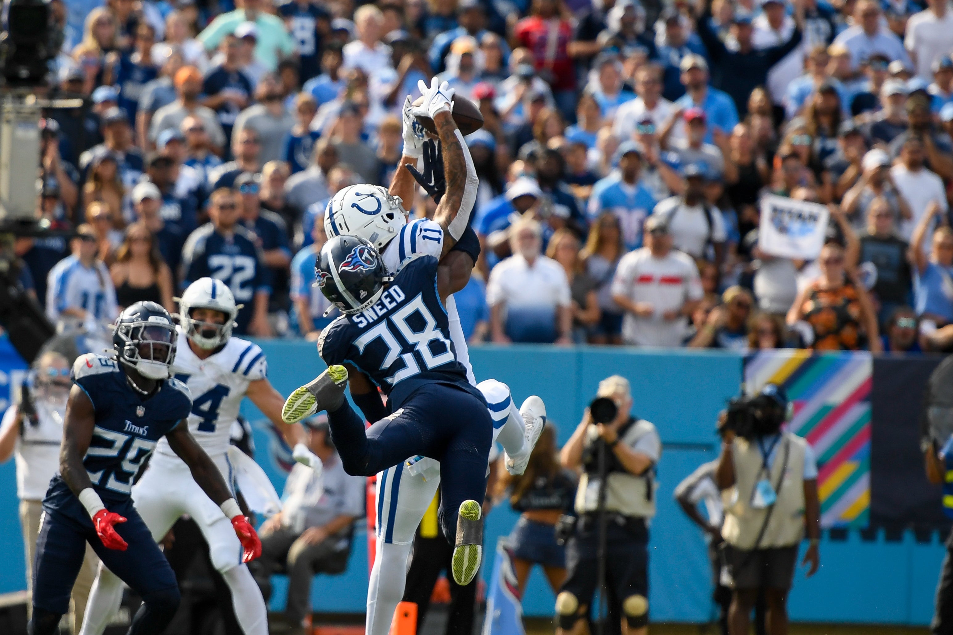 Oct 13, 2024; Nashville, Tennessee, USA; Indianapolis Colts wide receiver Michael Pittman Jr. (11) makes a touchdown catch over Tennessee Titans cornerback L'Jarius Sneed (38) during the second half at Nissan Stadium.