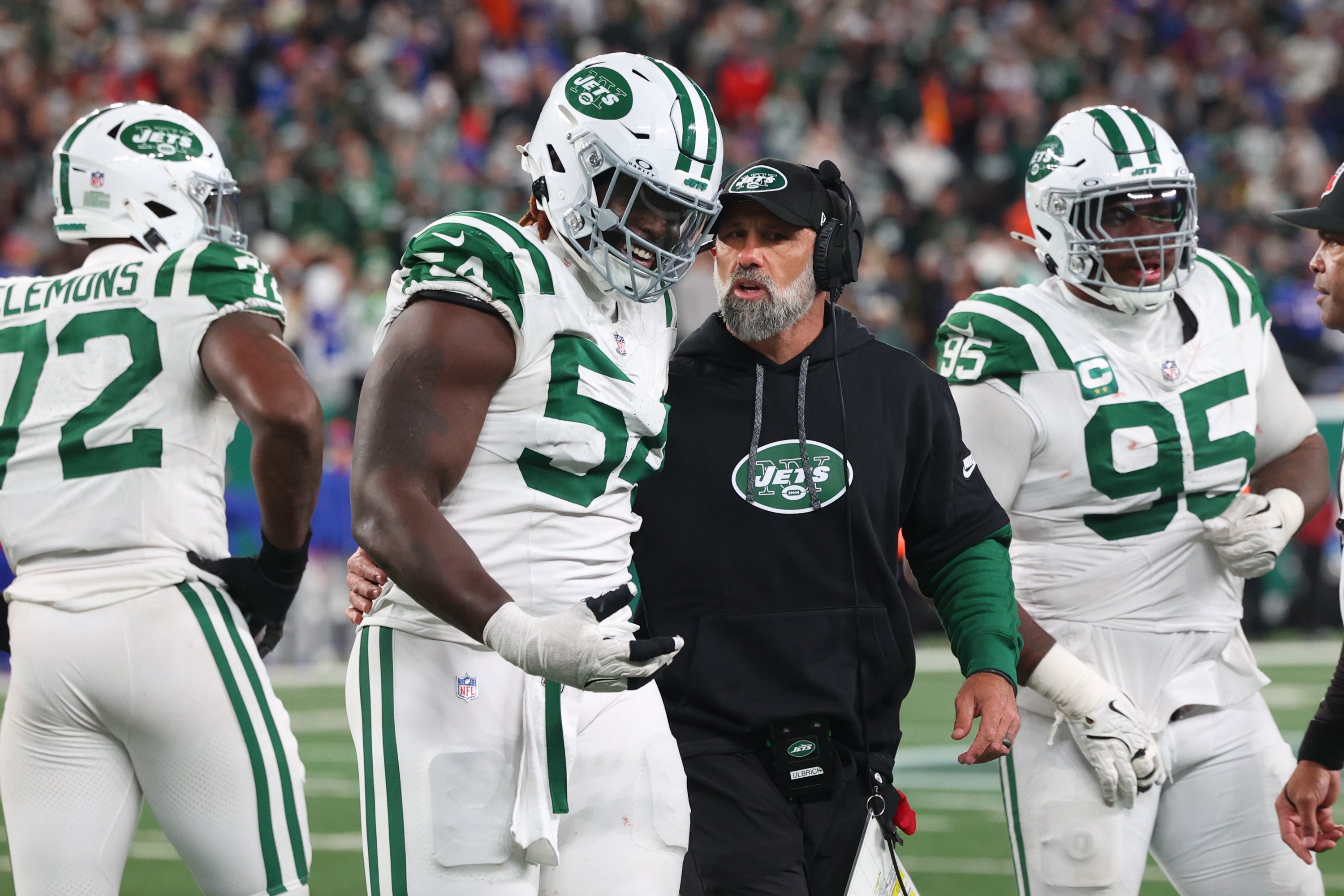 Jets head coach Jeff Ulbrich speaks with defensive tackle Javon Kinlaw