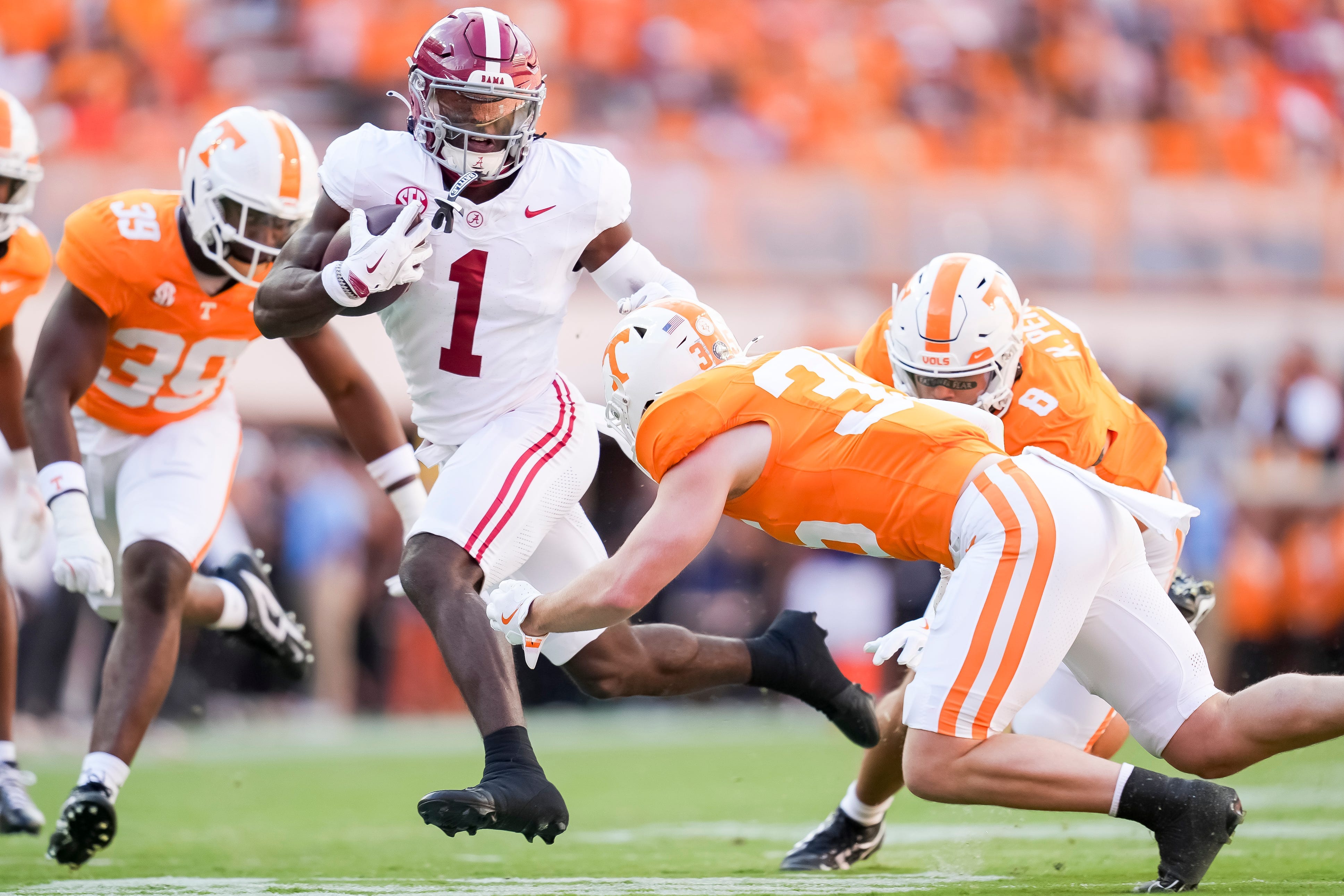 Alabama wide receiver Kendrick Law (1) runs with the ball against the Tennessee defense during their game at Neyland Stadium on Saturday, Oct. 19, 2024.