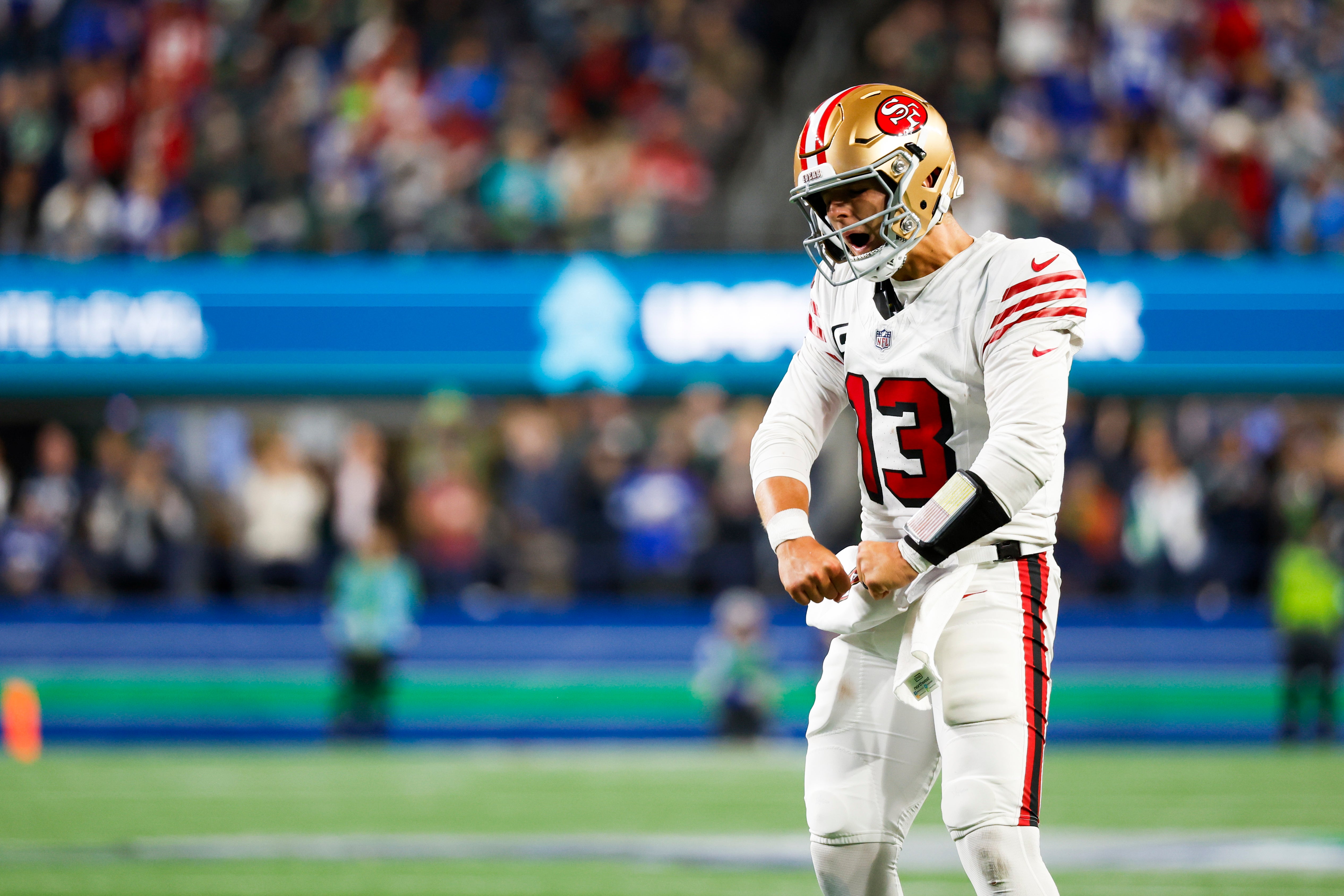 San Francisco 49ers quarterback Brock Purdy (13) celebrates after throwing a touchdown pass against the Seattle Seahawks during the third quarter at Lumen Field.