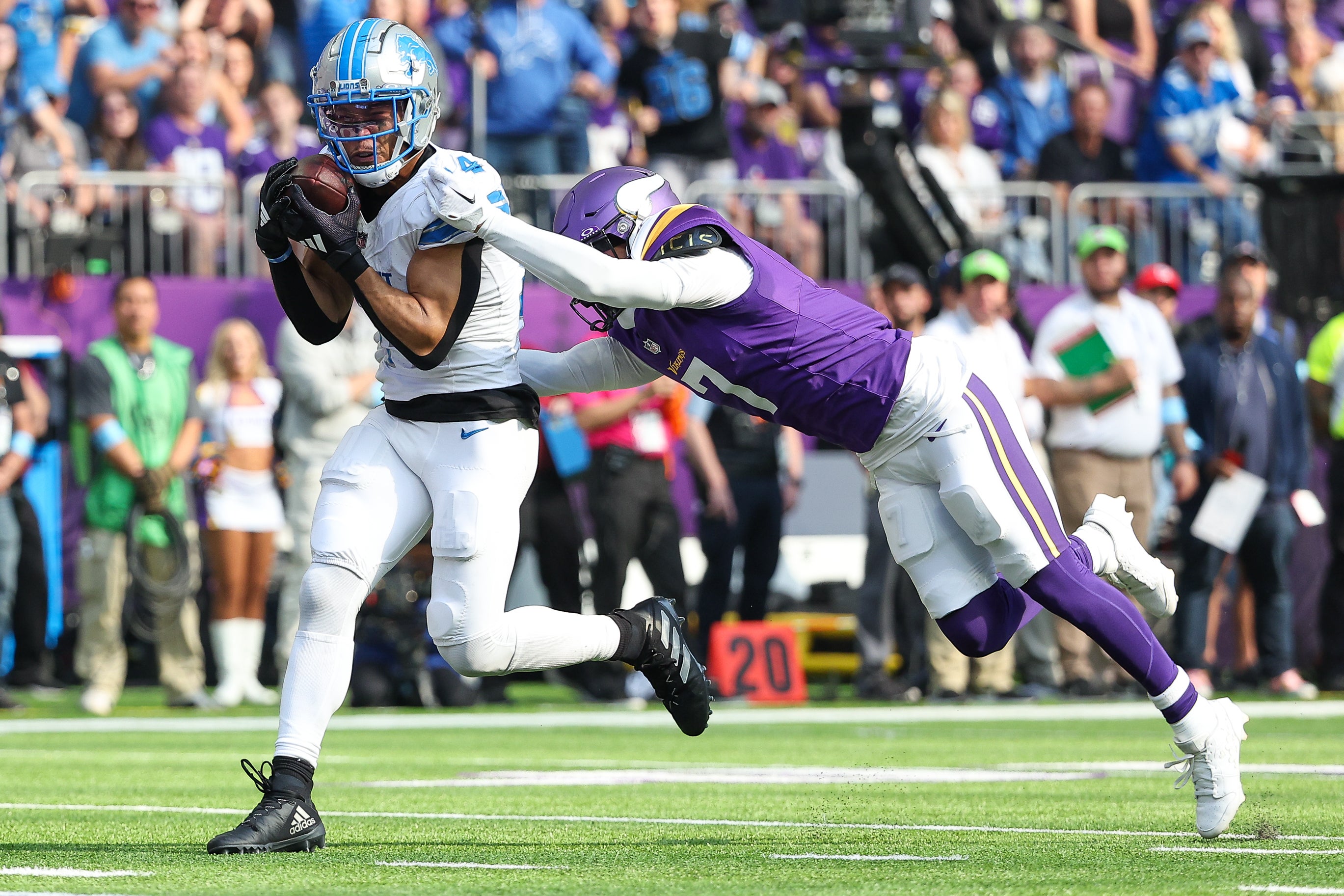 Oct 20, 2024; Minneapolis, Minnesota, USA; Detroit Lions wide receiver Amon-Ra St. Brown (14) catches a pass for a touchdown against the Minnesota Vikings during the second quarter at U.S. Bank Stadium.
